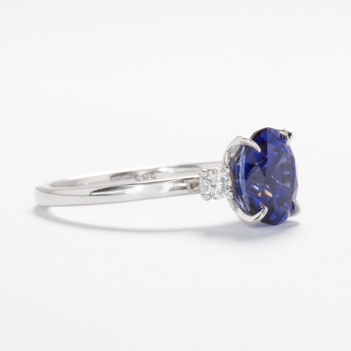 royal blue lab sapphire three stone engagement ring in white gold