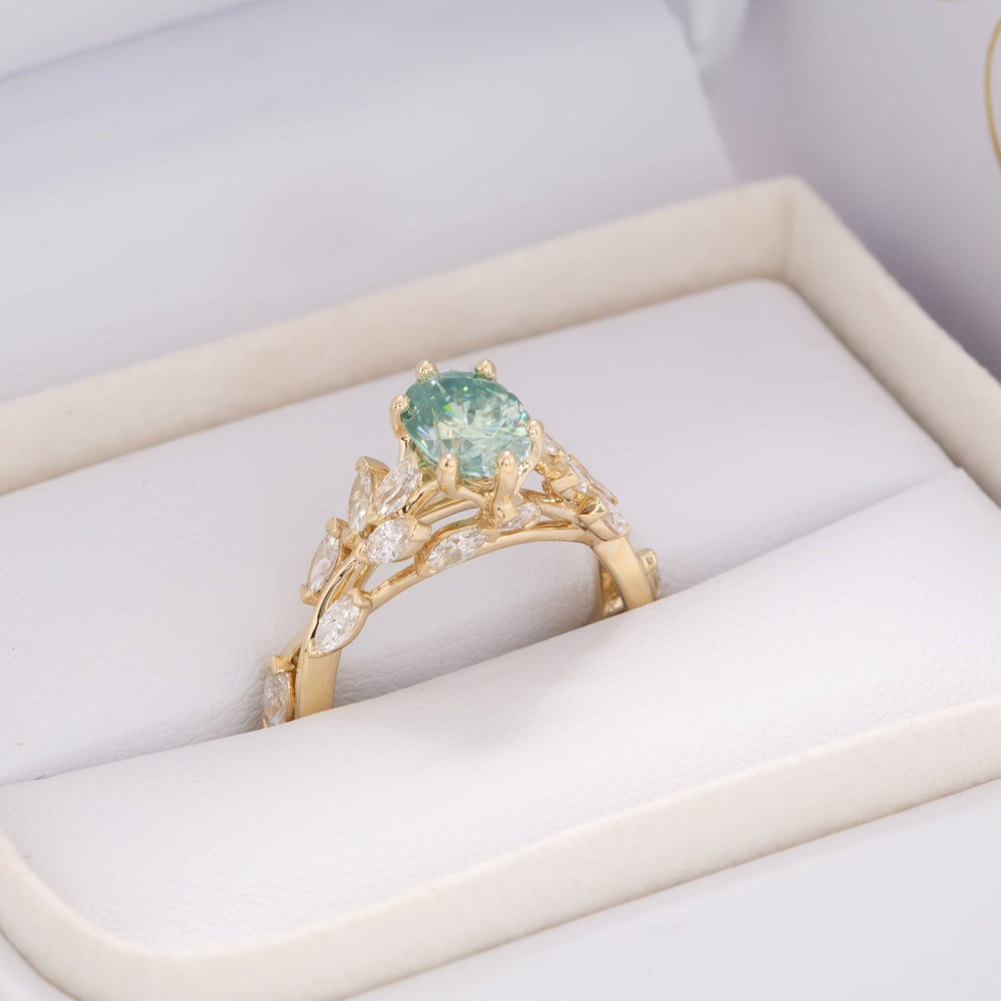 senna nature inspired engagement ring with oval blue-green moissanite