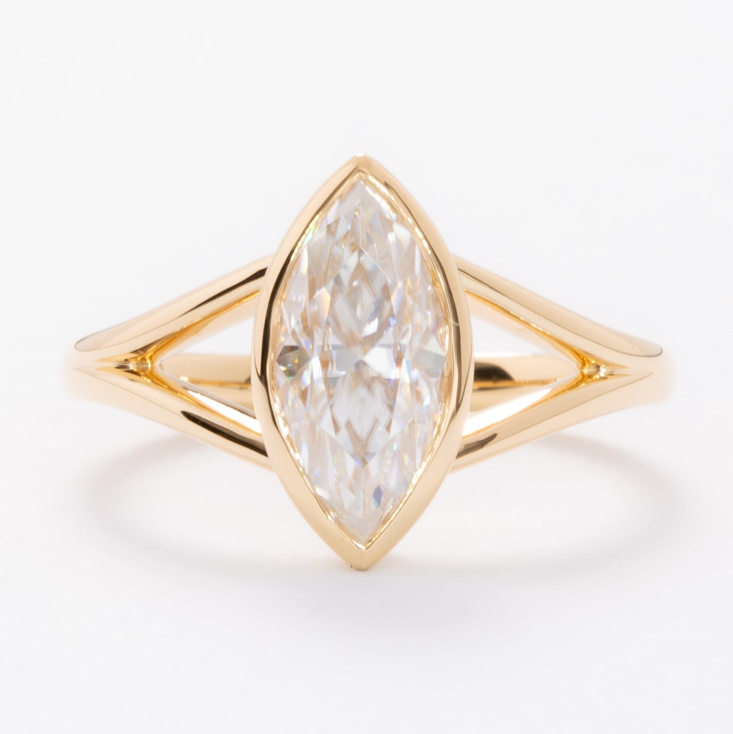 shion bezel set split shank solitaire with marquise moissanite