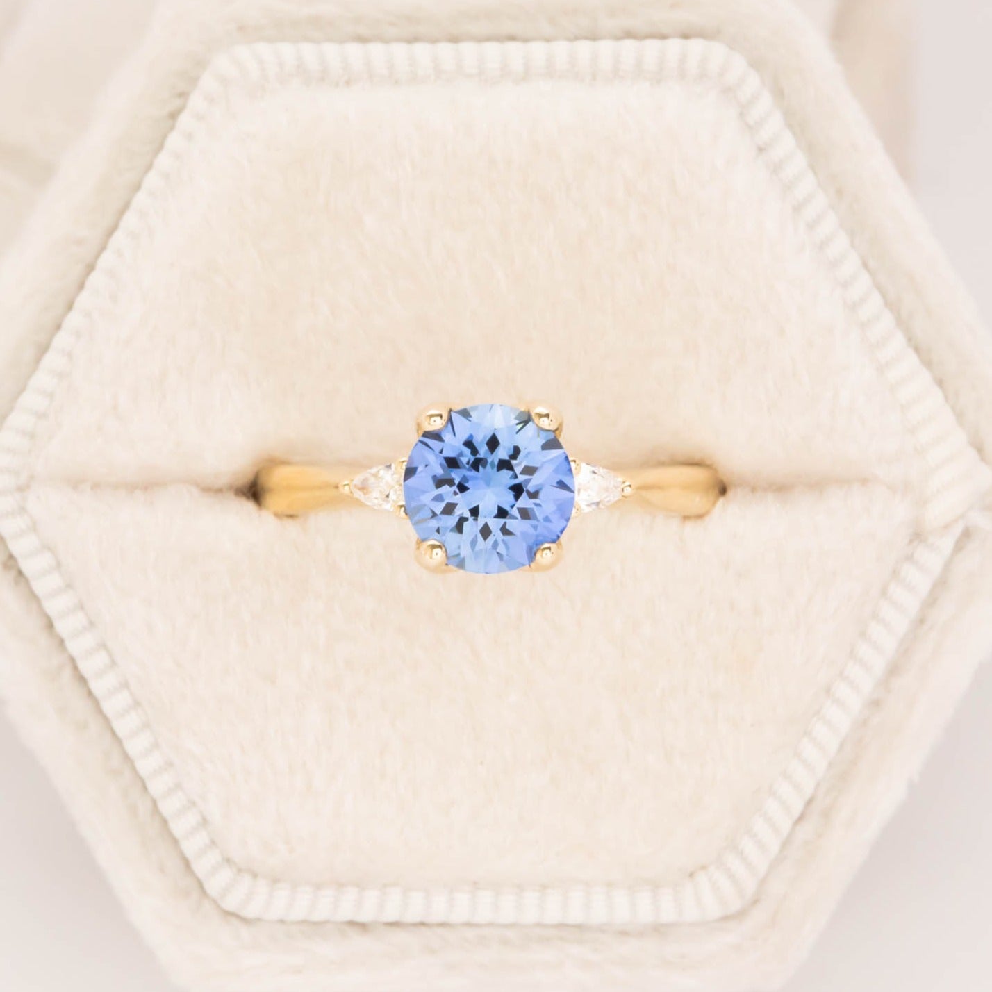 three stone engagement ring with blue lab sapphire