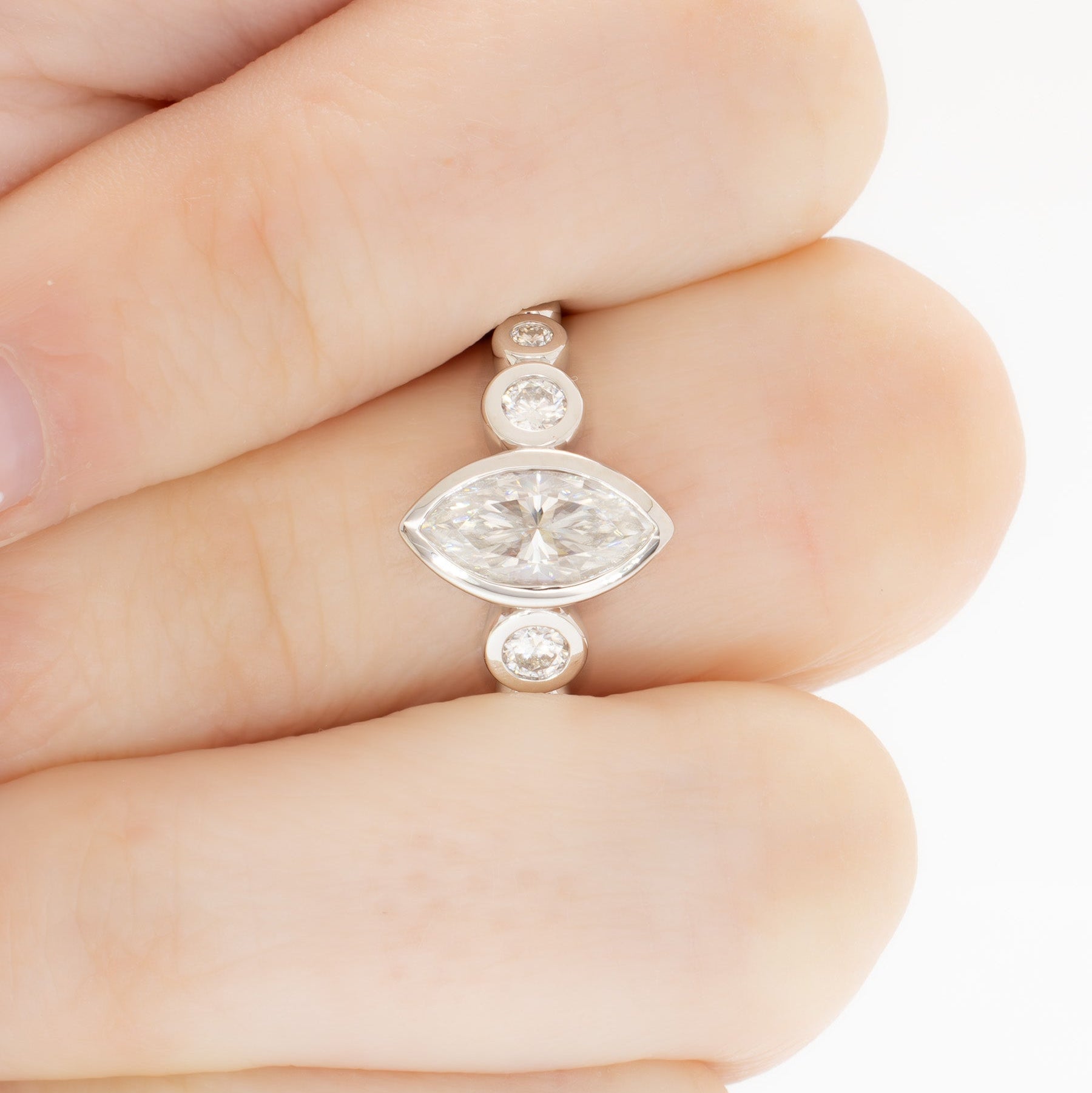 Aisha bezel set engagement ring with white moissanite marquise