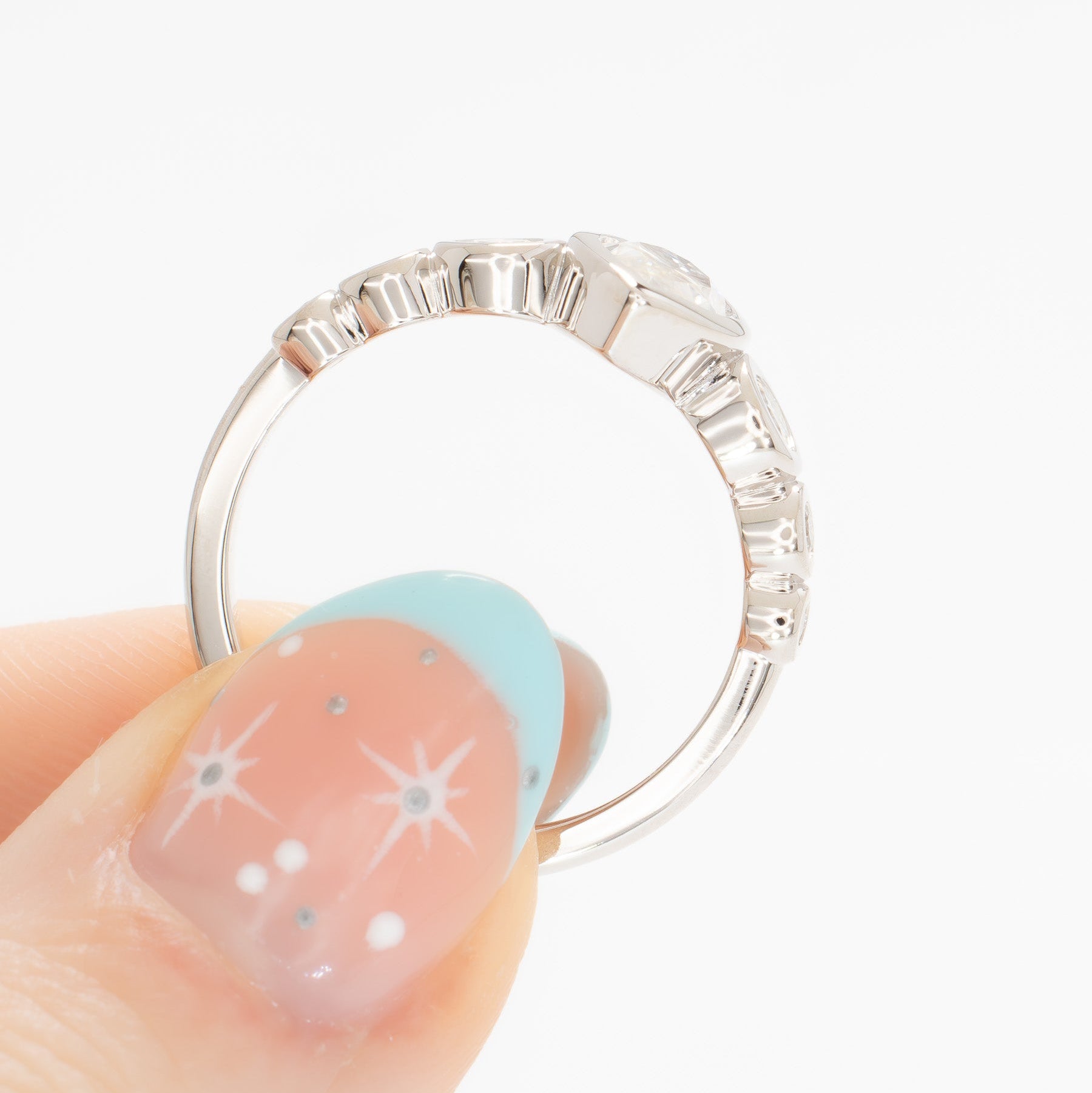 Aisha bezel set engagement ring with white moissanite marquise