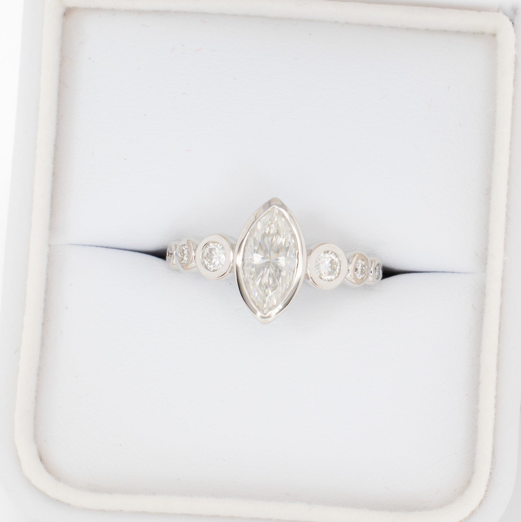 Aisha bezel set engagement ring with white moissanite marquise
