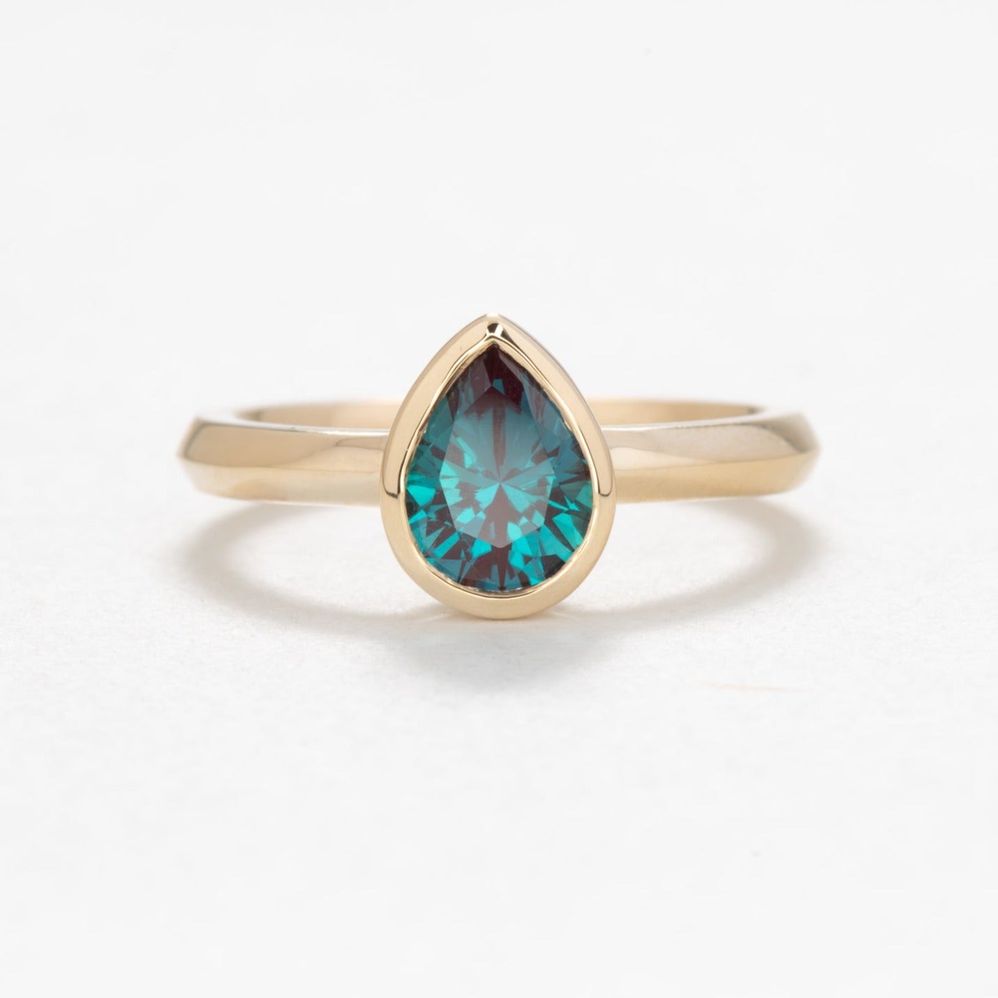 alexandra engagement ring with alexandrite pear bezel
