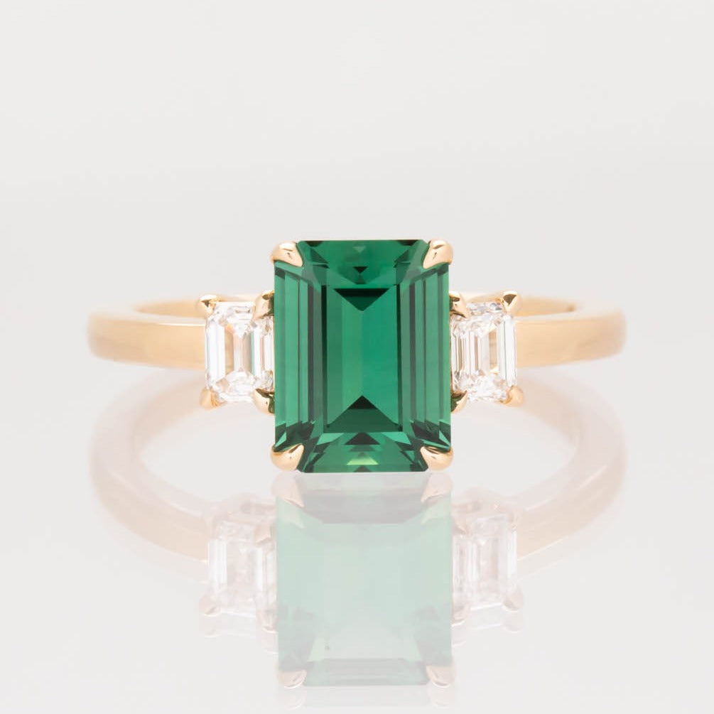 Ami three stone engagement ring with step cut lab sapphire