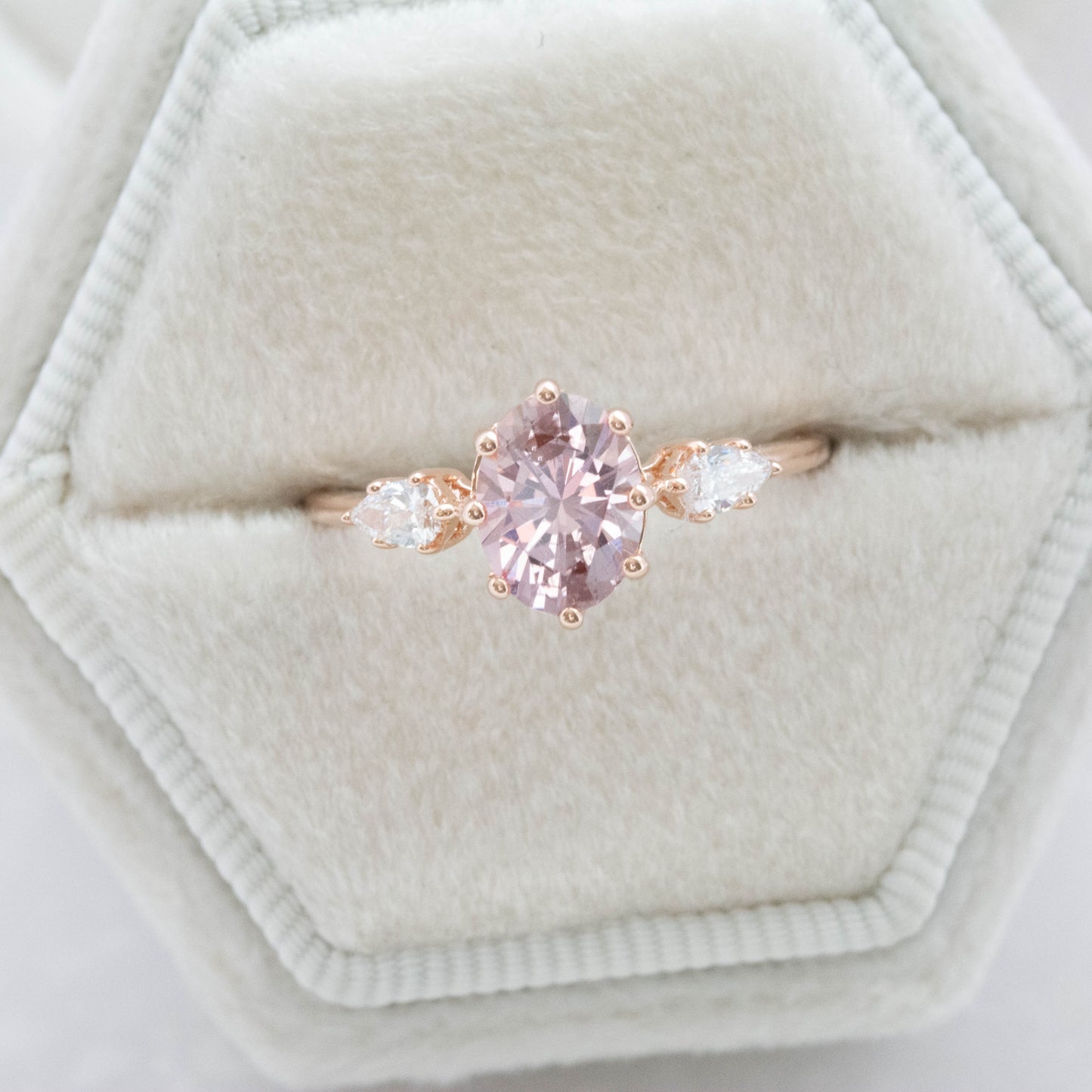three stone engagement ring with peach oval lab sapphire