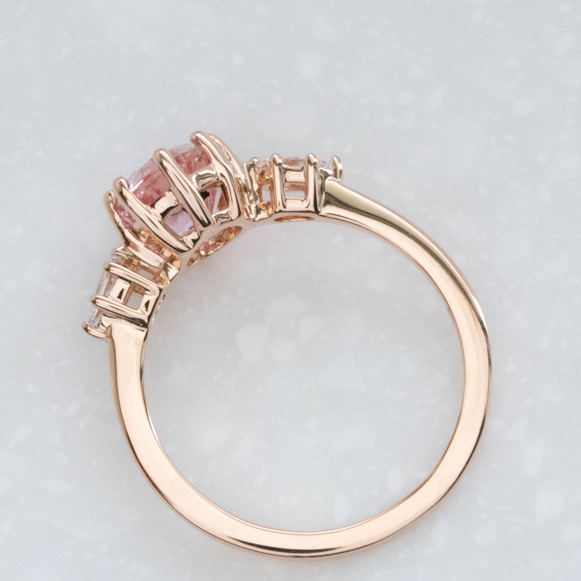 three stone engagement ring with peach oval lab sapphire