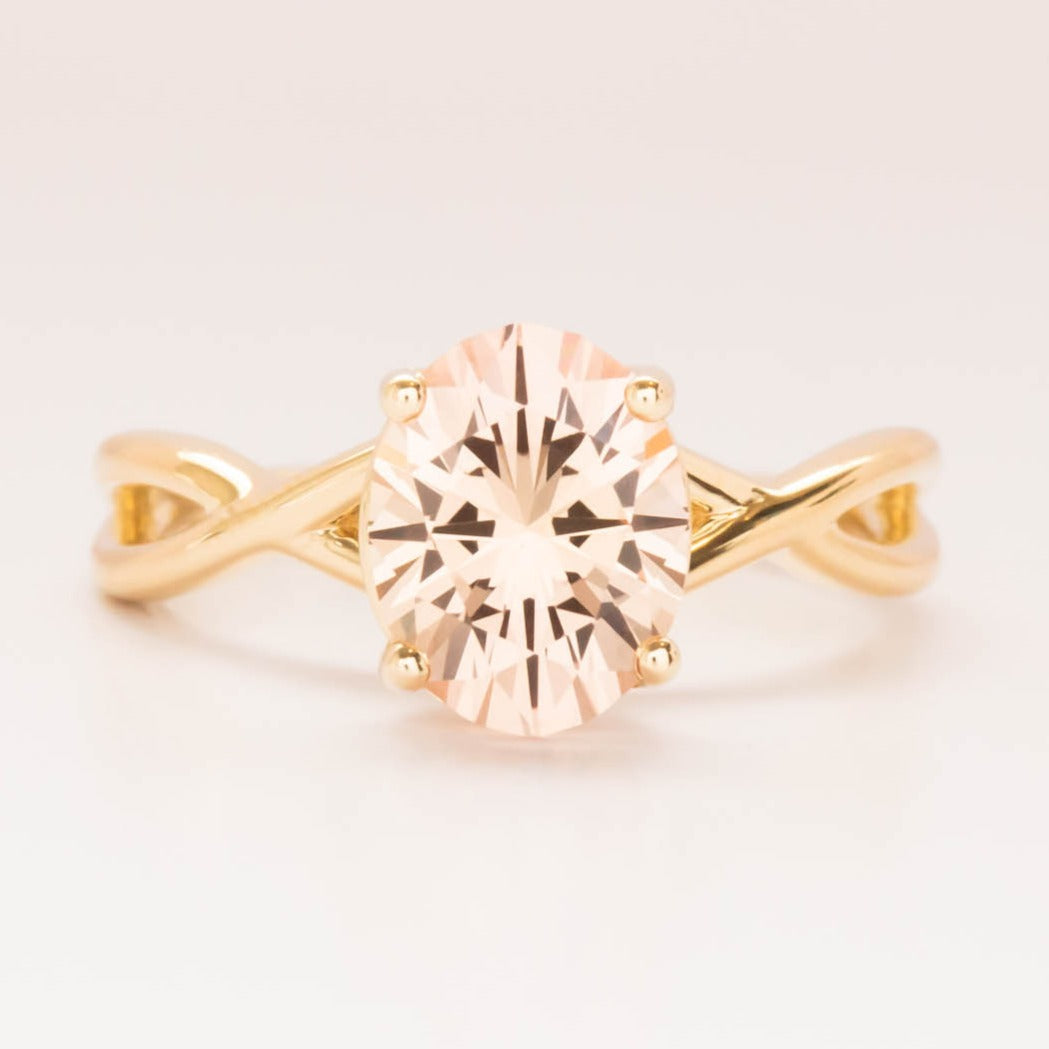 Fifer solitaire engagement ring with peach oval lab sapphire