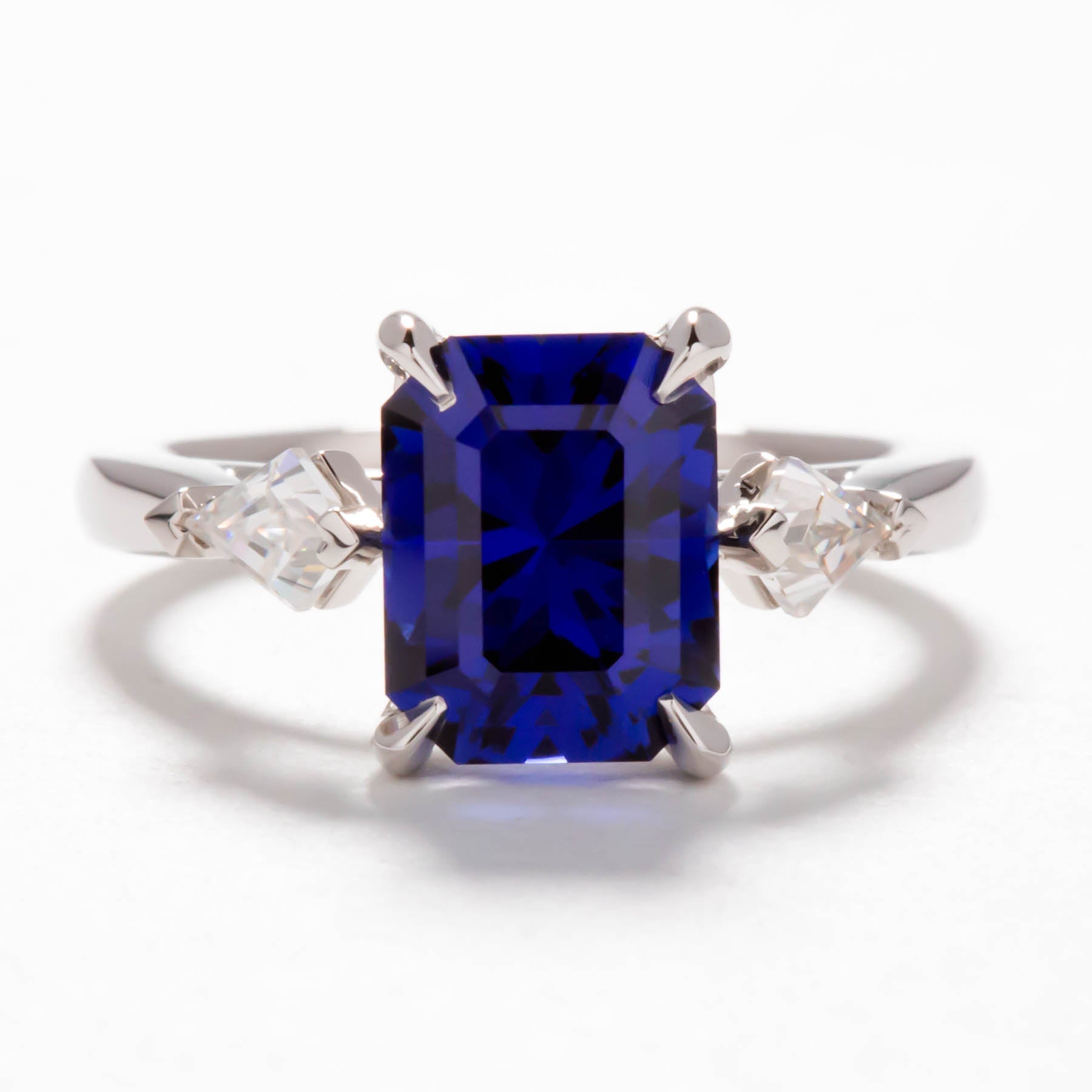 Jamie three stone engagement ring with step cut lab sapphire