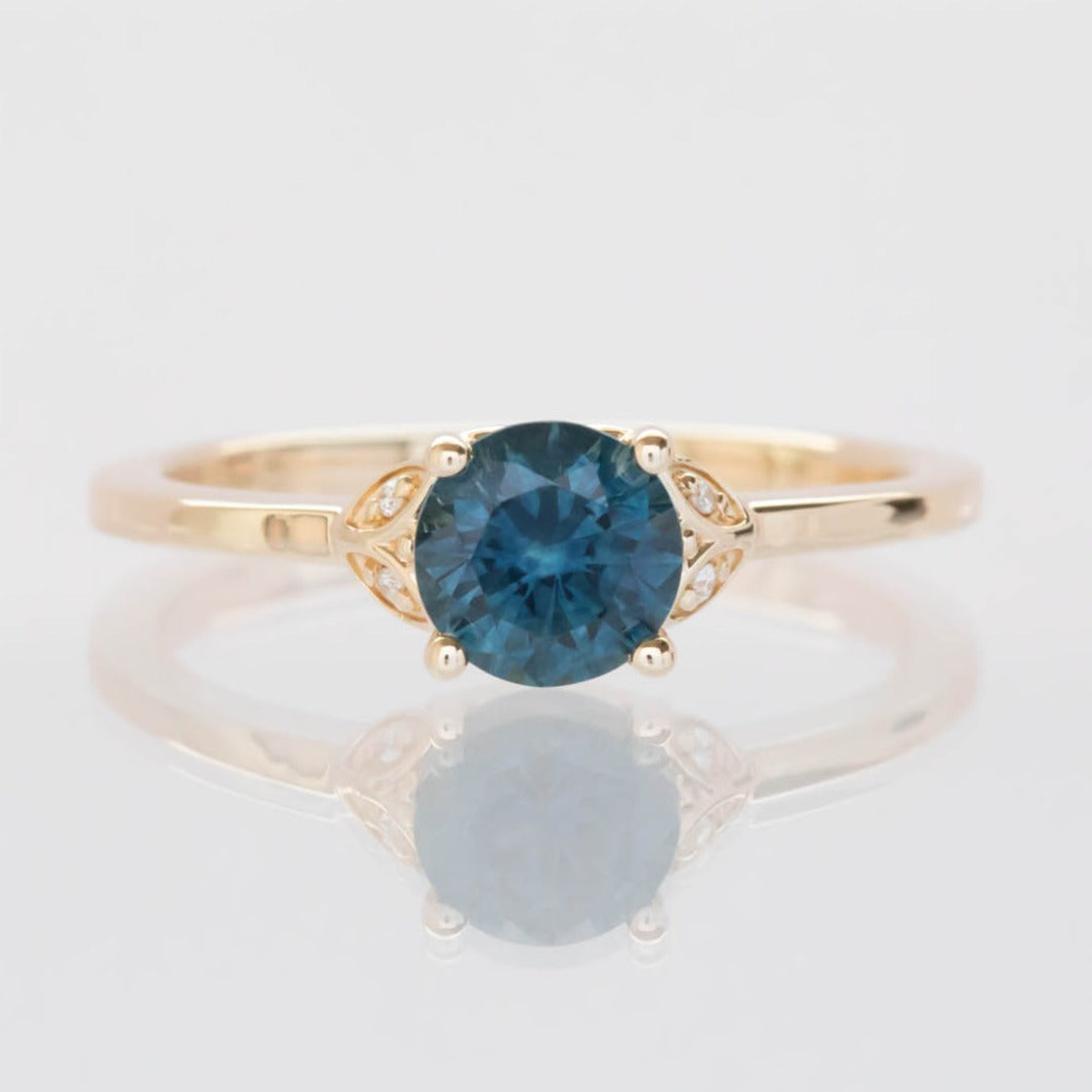 yellow gold engagement ring with montana sapphire round