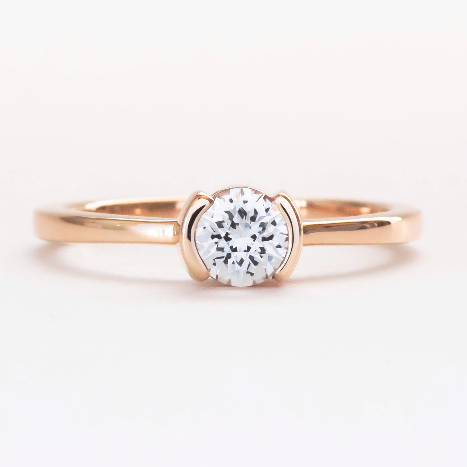 Reese half bezel solitaire engagement ring with lab sapphire