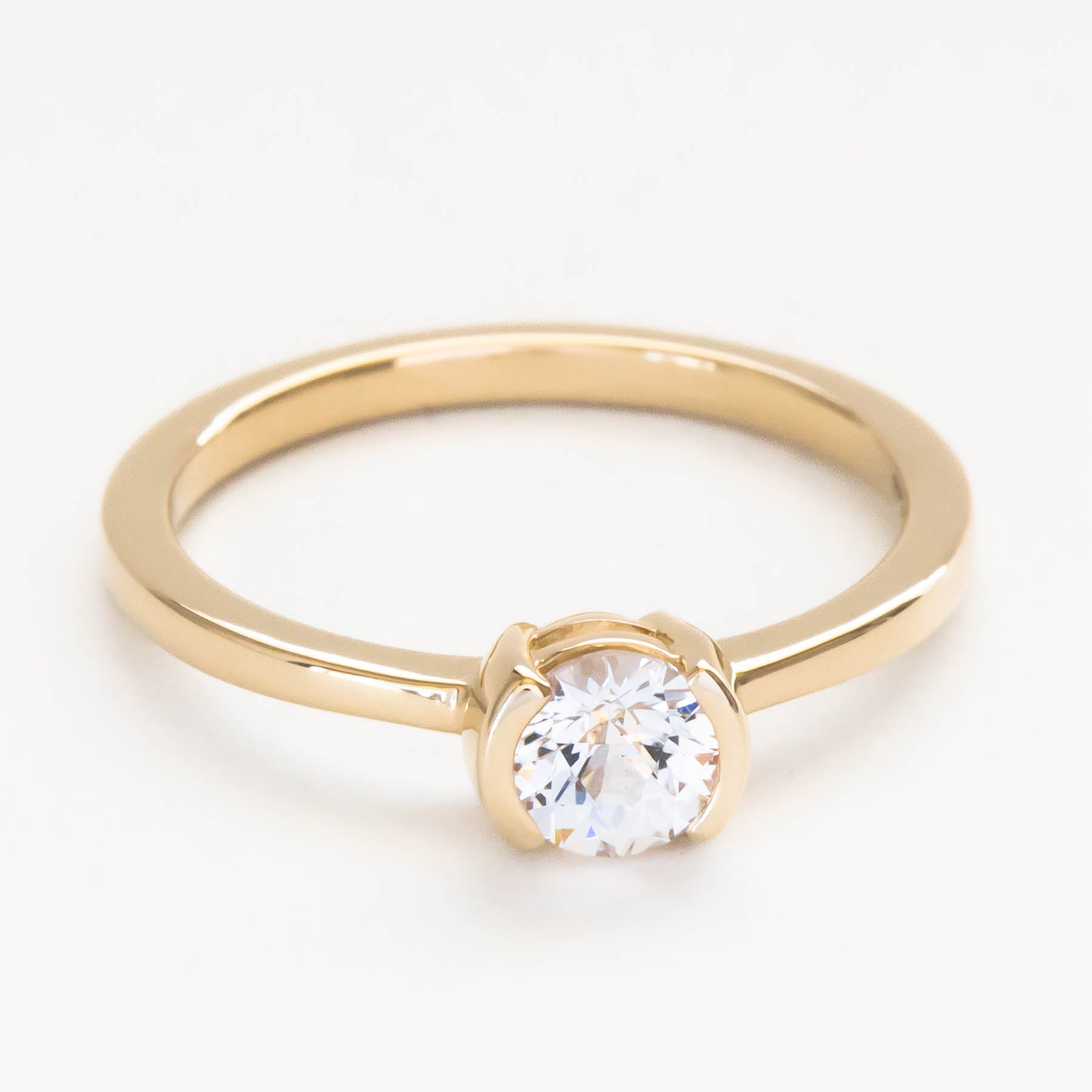 Reese half bezel solitaire engagement ring with lab sapphire