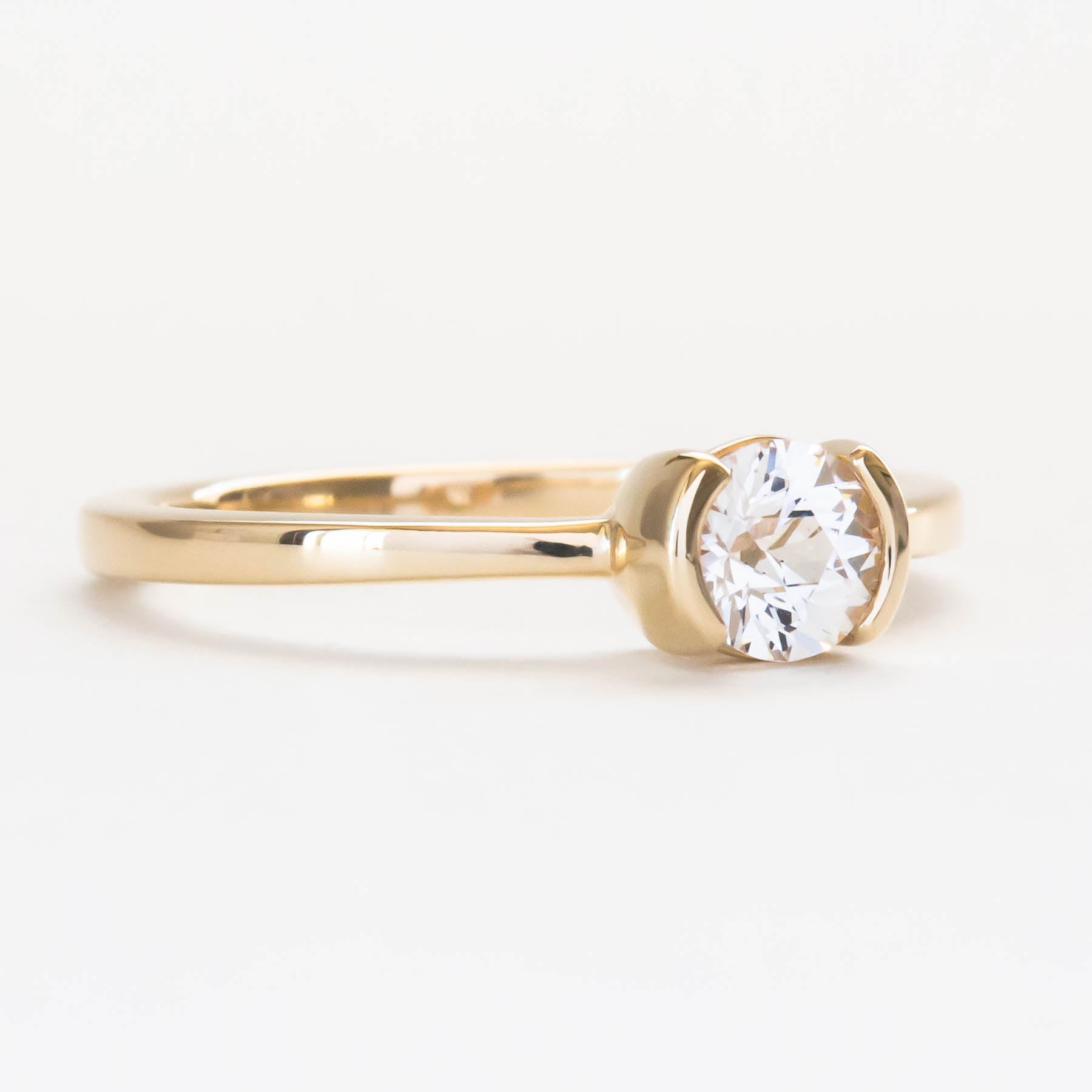 Reese half bezel solitaire engagement ring with lab sapphire