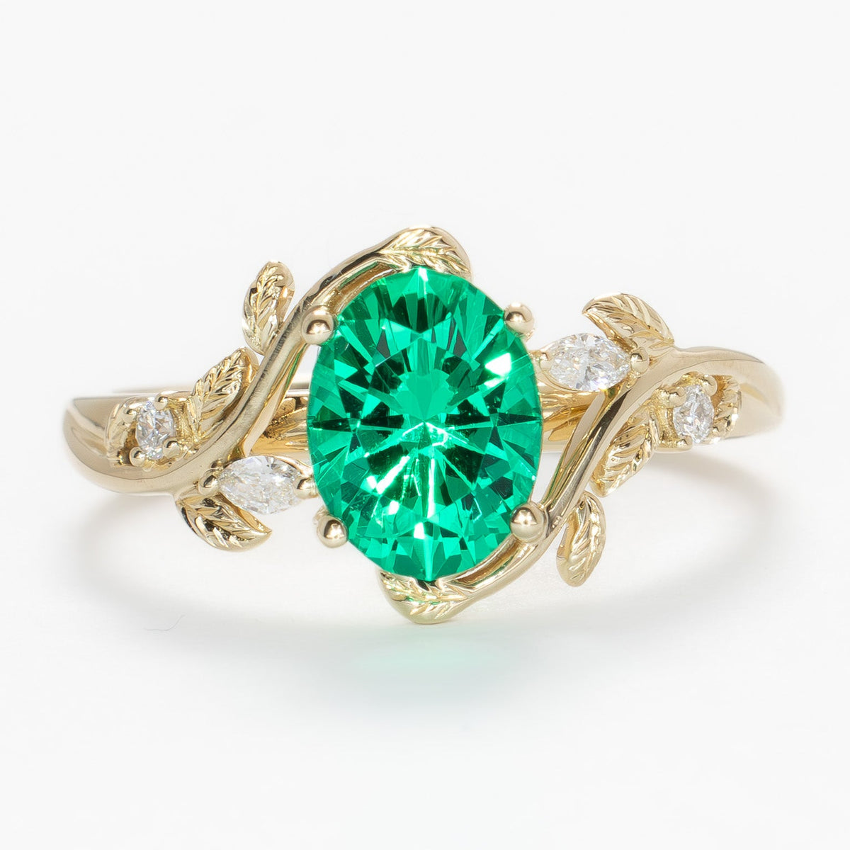 airam nature inspired ring in yellow gold with oval lab emerald