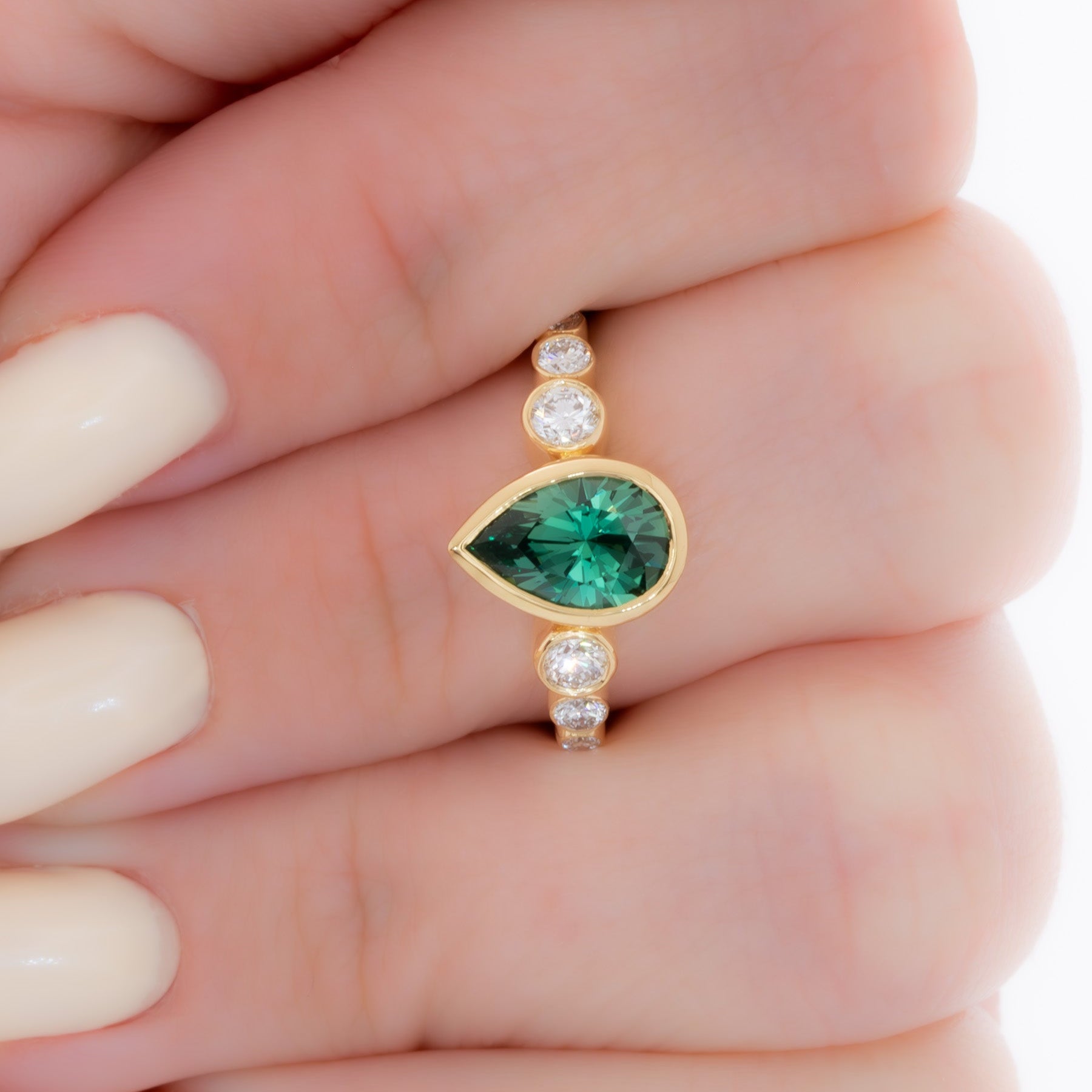 aisha bezel set ring with green lab sapphire pear