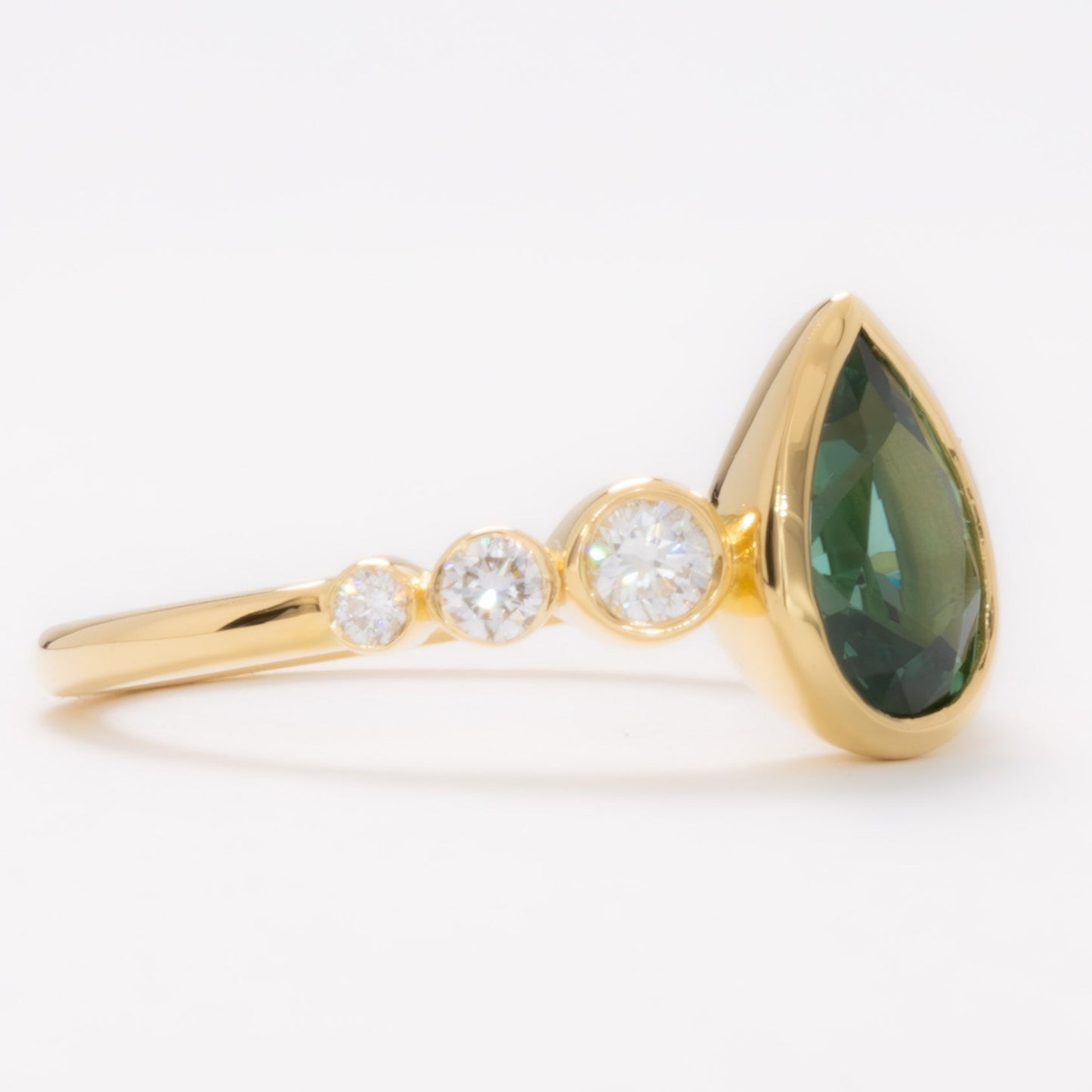 aisha bezel set ring with green lab sapphire pear