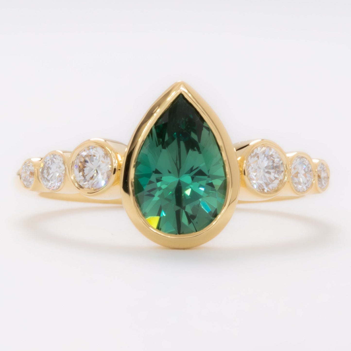 aisha bezel set ring with green lab sapphire pear