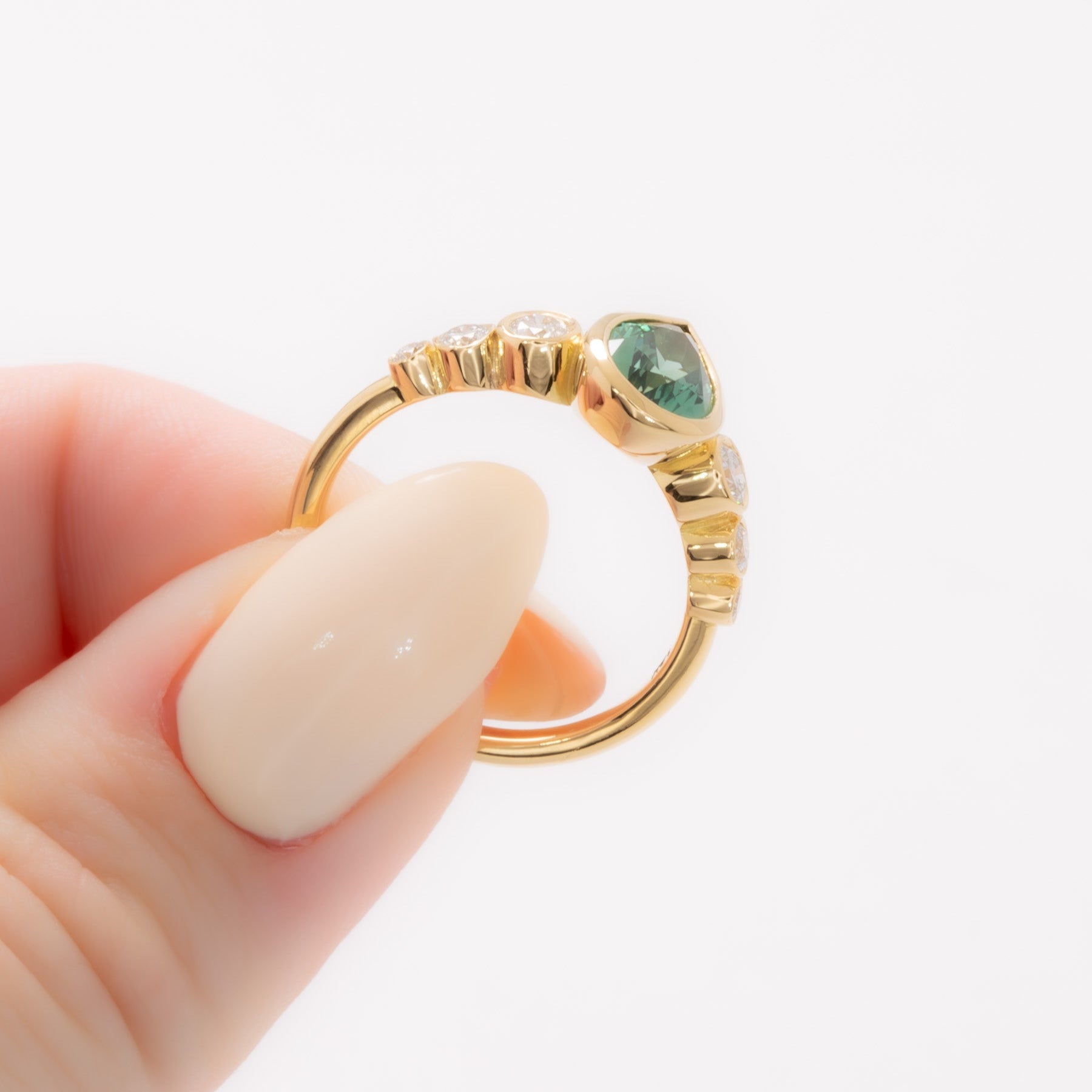 aisha bezel set ring with green lab sapphire pear