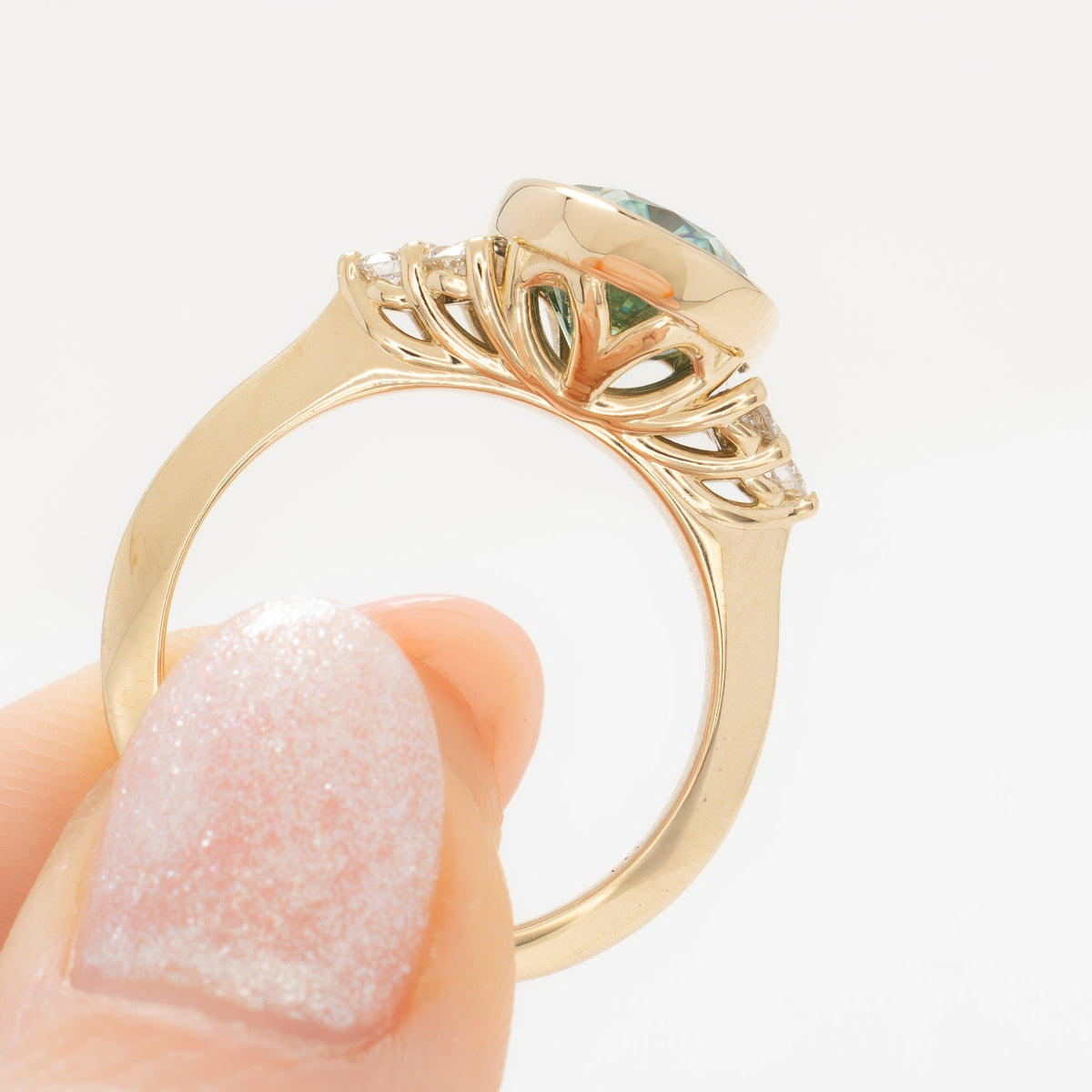 alinta bezel set accented ring in yellow gold with green moissanite oval