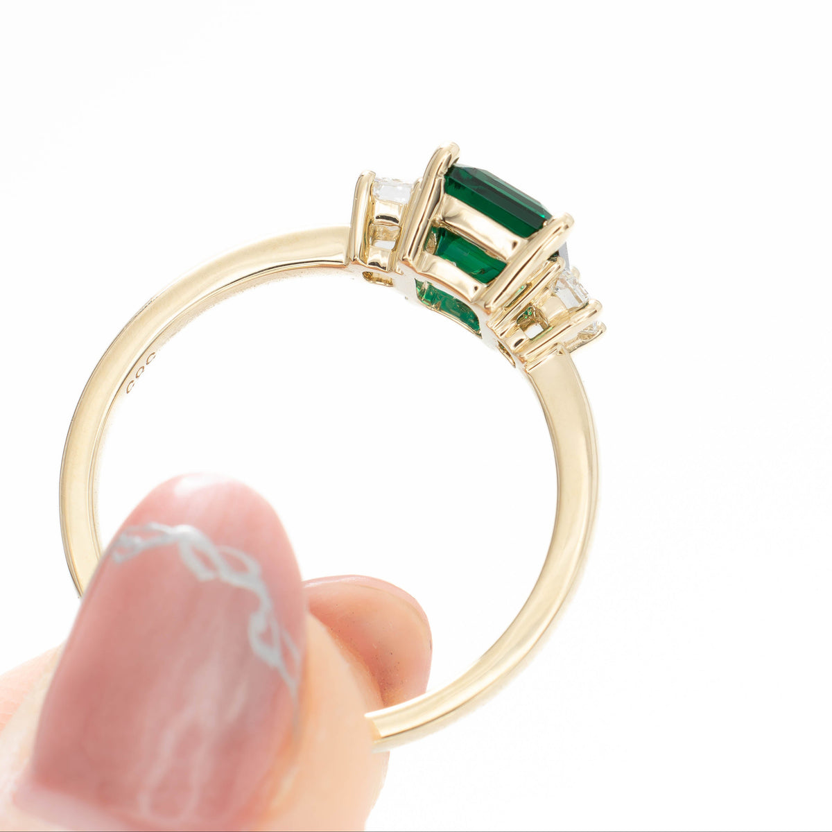ami three stone ring in yellow gold with step cut lab emerald
