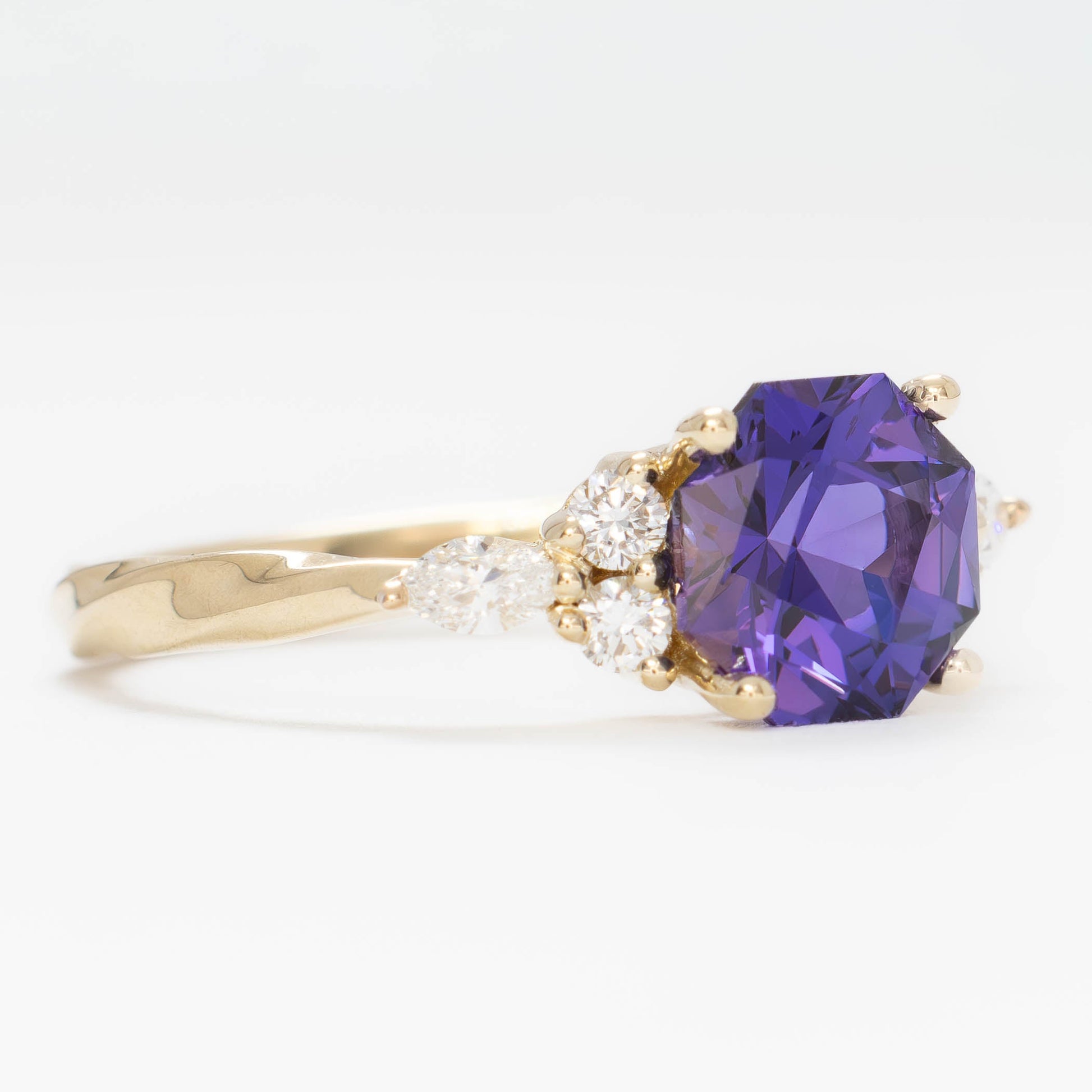ardene engagement ring with purple lab sapphire in yellow gold