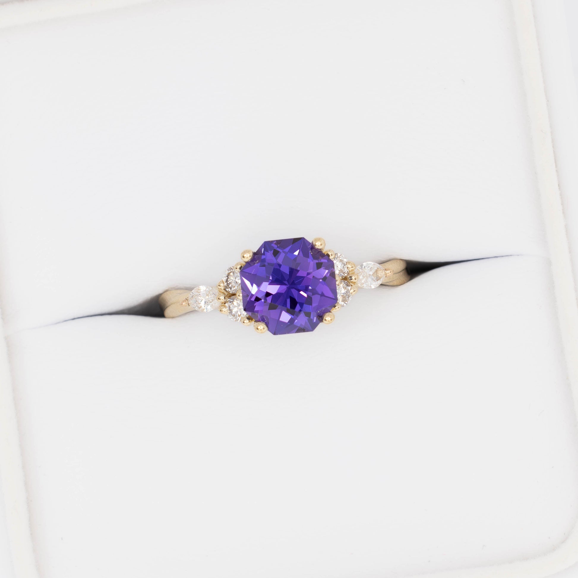 ardene engagement ring with purple lab sapphire in yellow gold