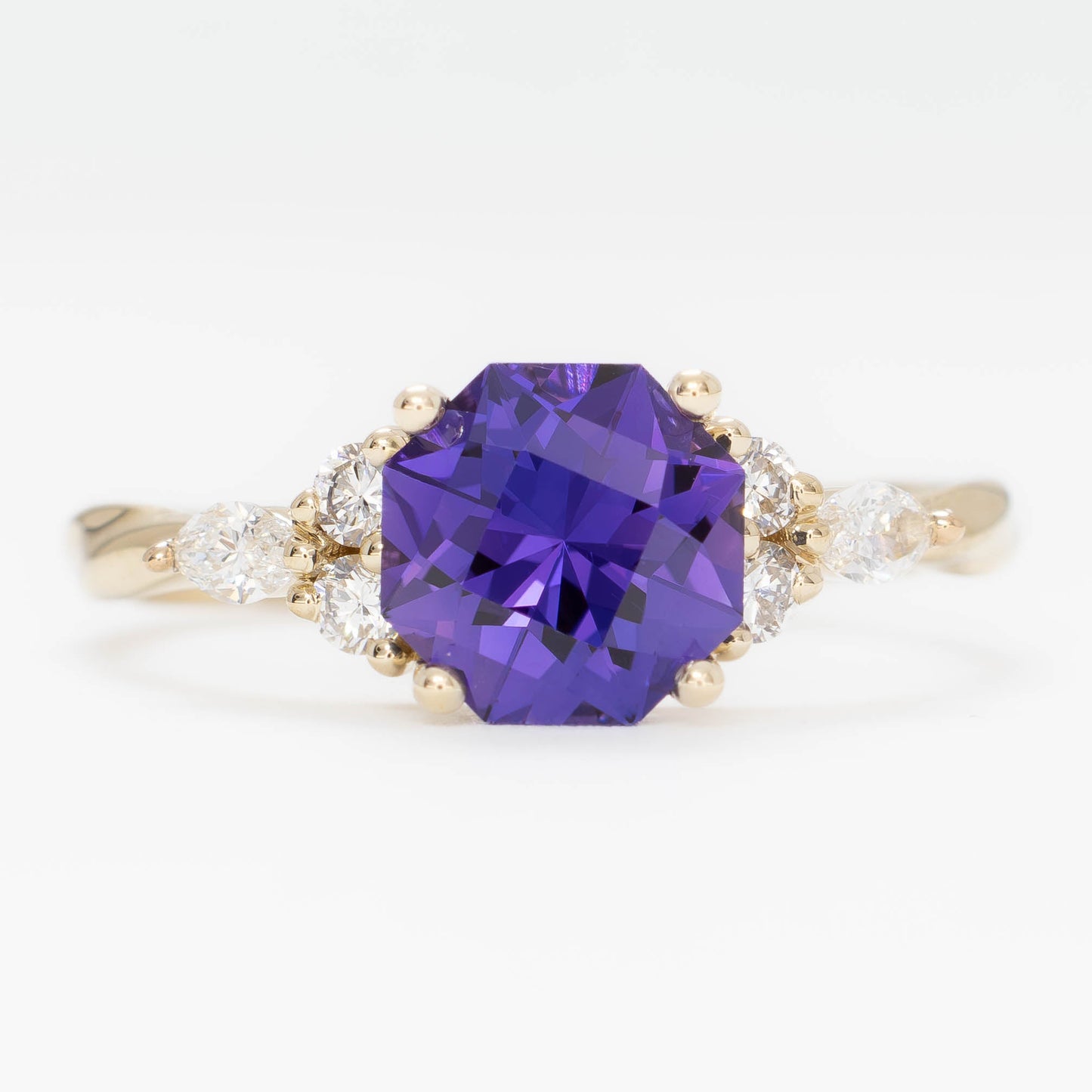 ardene engagement ring with purple lab sapphire in yellow gold