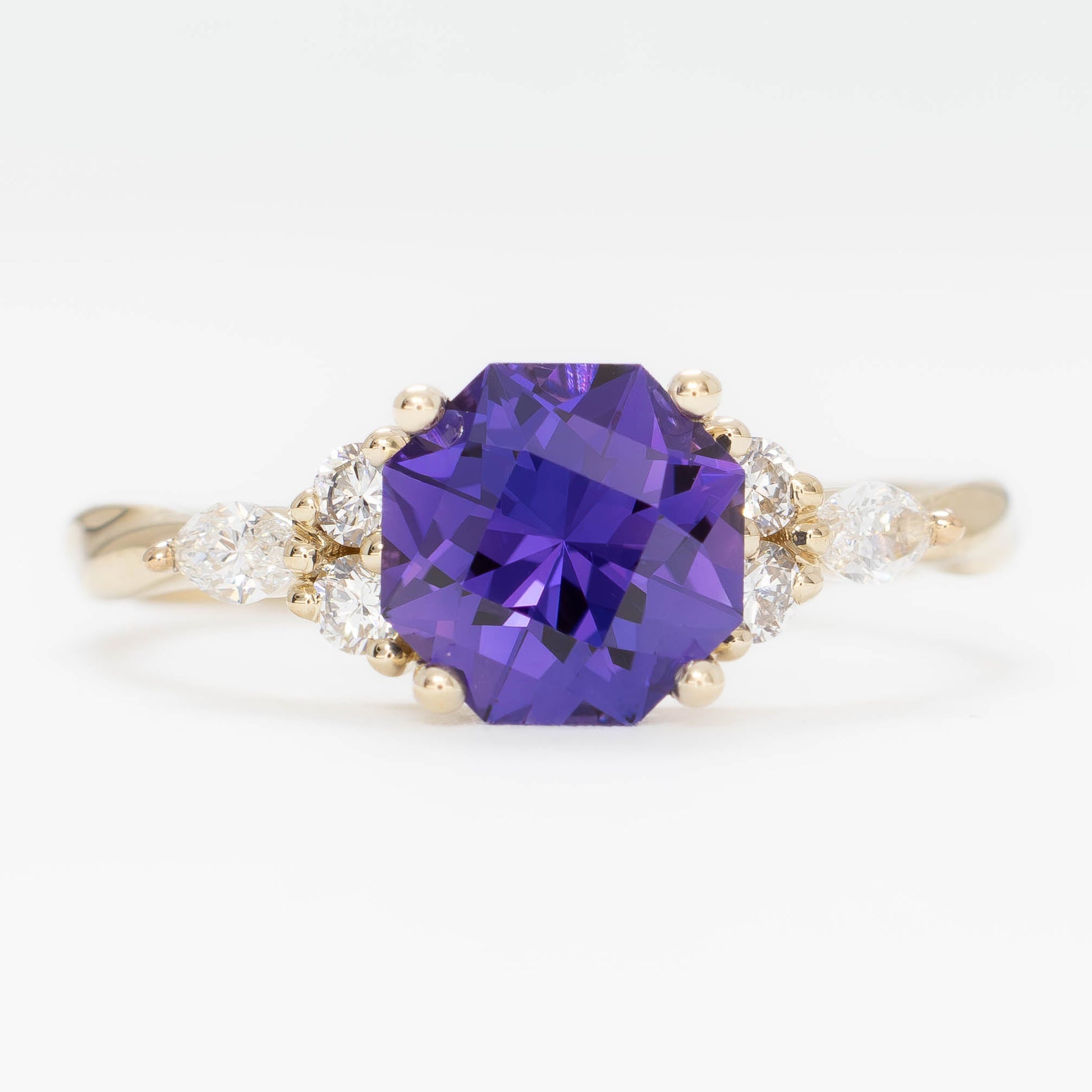 ardene engagement ring with purple lab sapphire in yellow gold