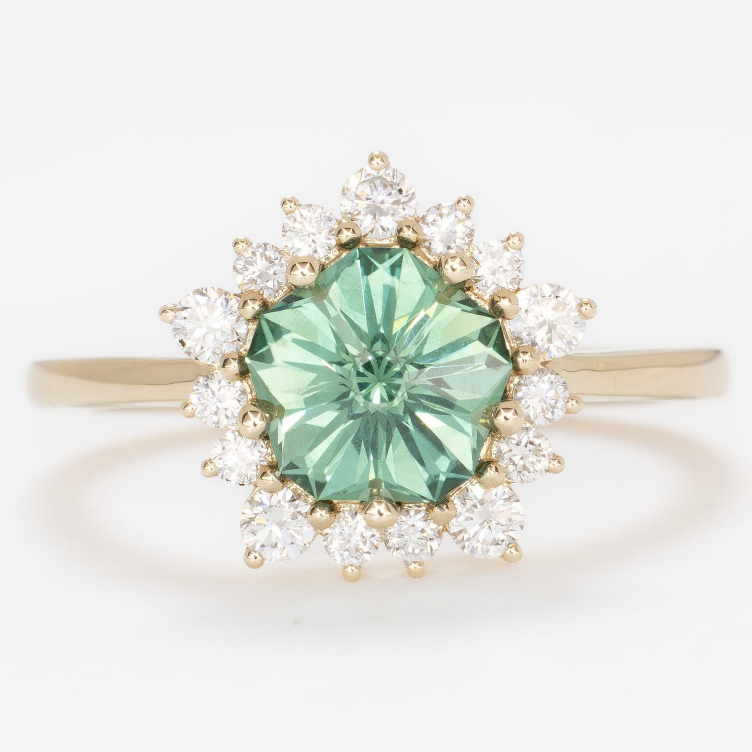 aurora snowflake inspired halo engagement ring with a green lab sapphire hanami pentagon