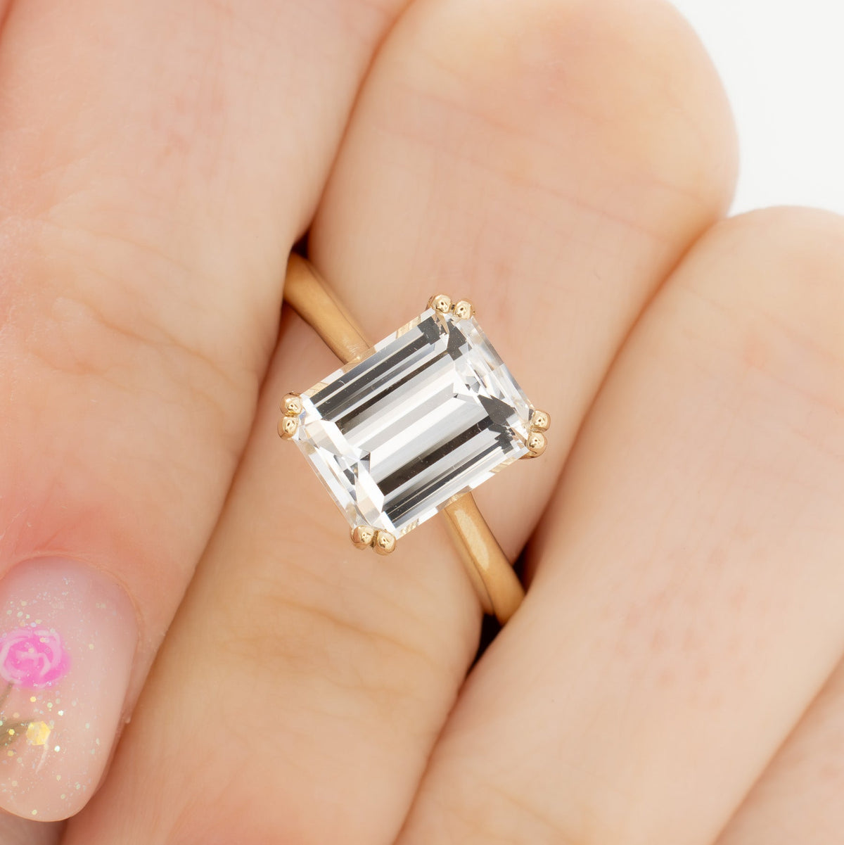 bailey solitaire ring in yellow gold with step cut white lab sapphire