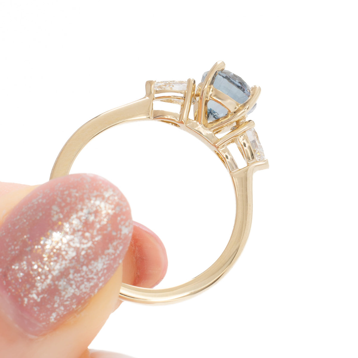 beckett three stone ring in yellow gold with oval blue-green lab sapphire