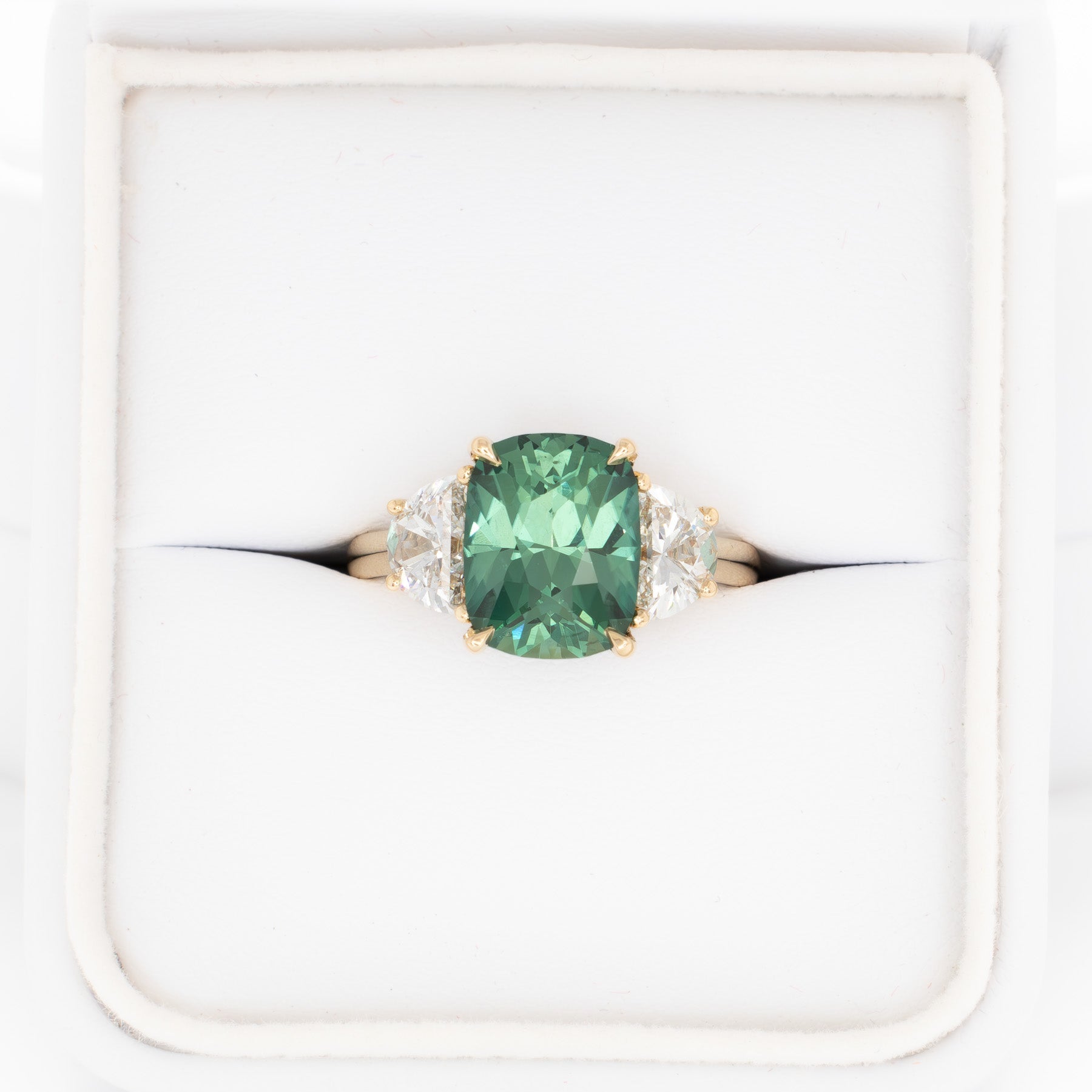 brigid half moon three stone engagement ring with elongated cushion green lab sapphire