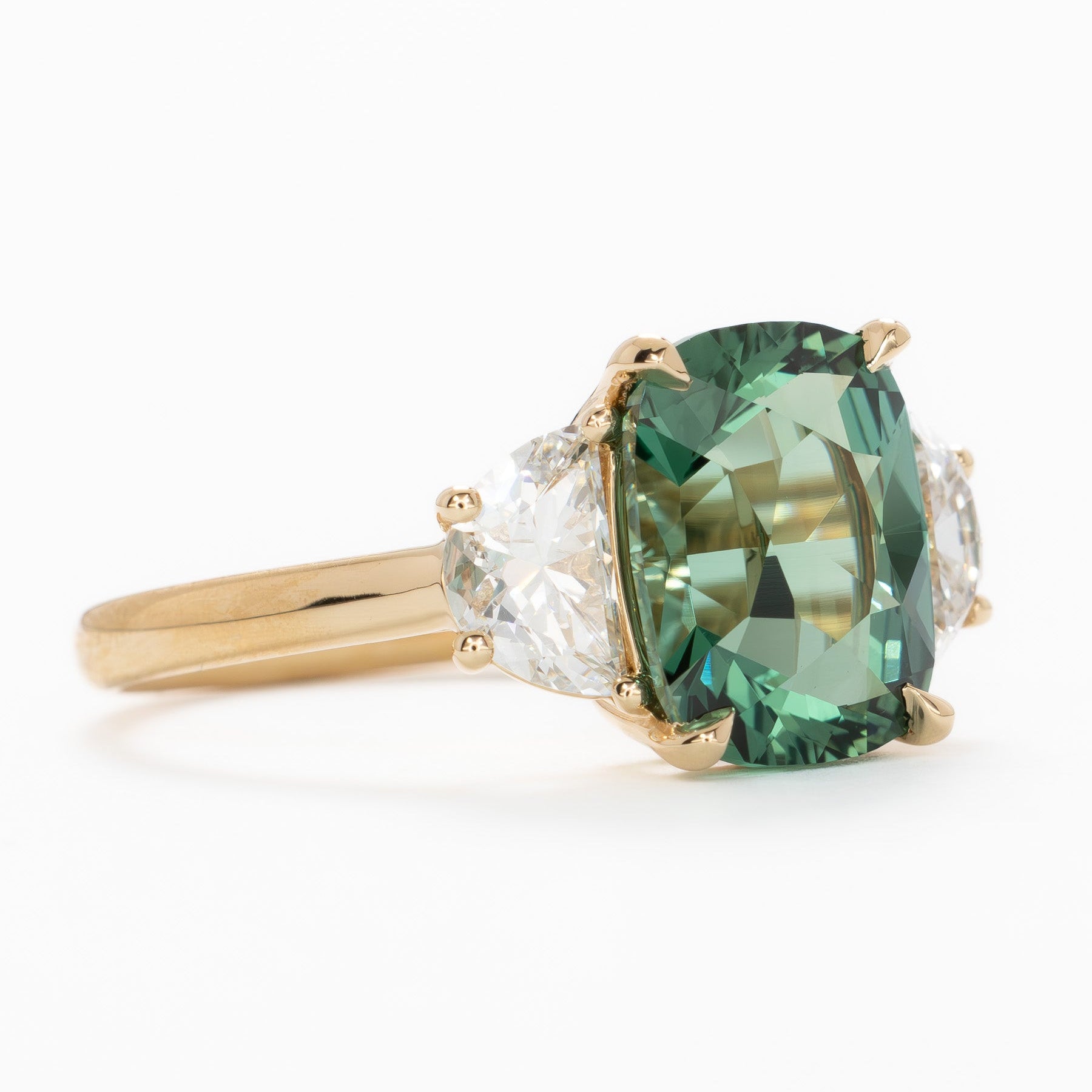 brigid half moon three stone engagement ring with elongated cushion green lab sapphire