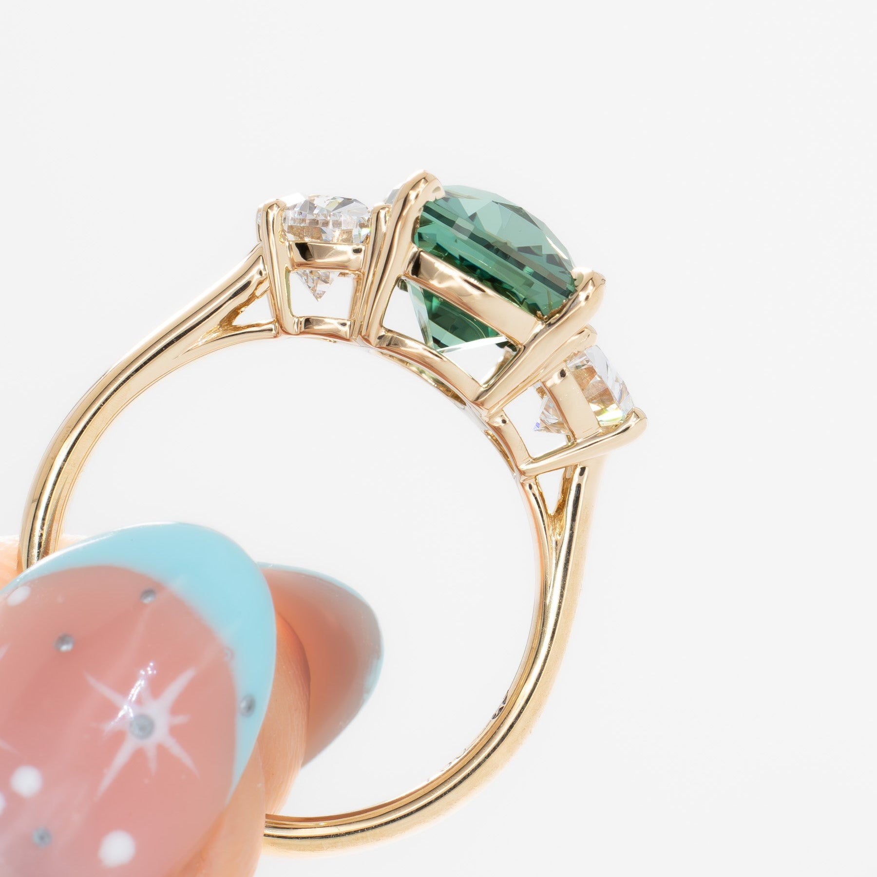 brigid half moon three stone engagement ring with elongated cushion green lab sapphire