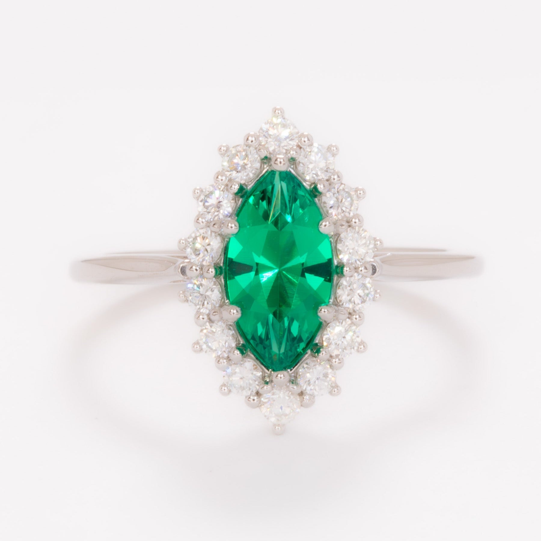 calypso halo engagement ring in white gold and marquise lab emerald