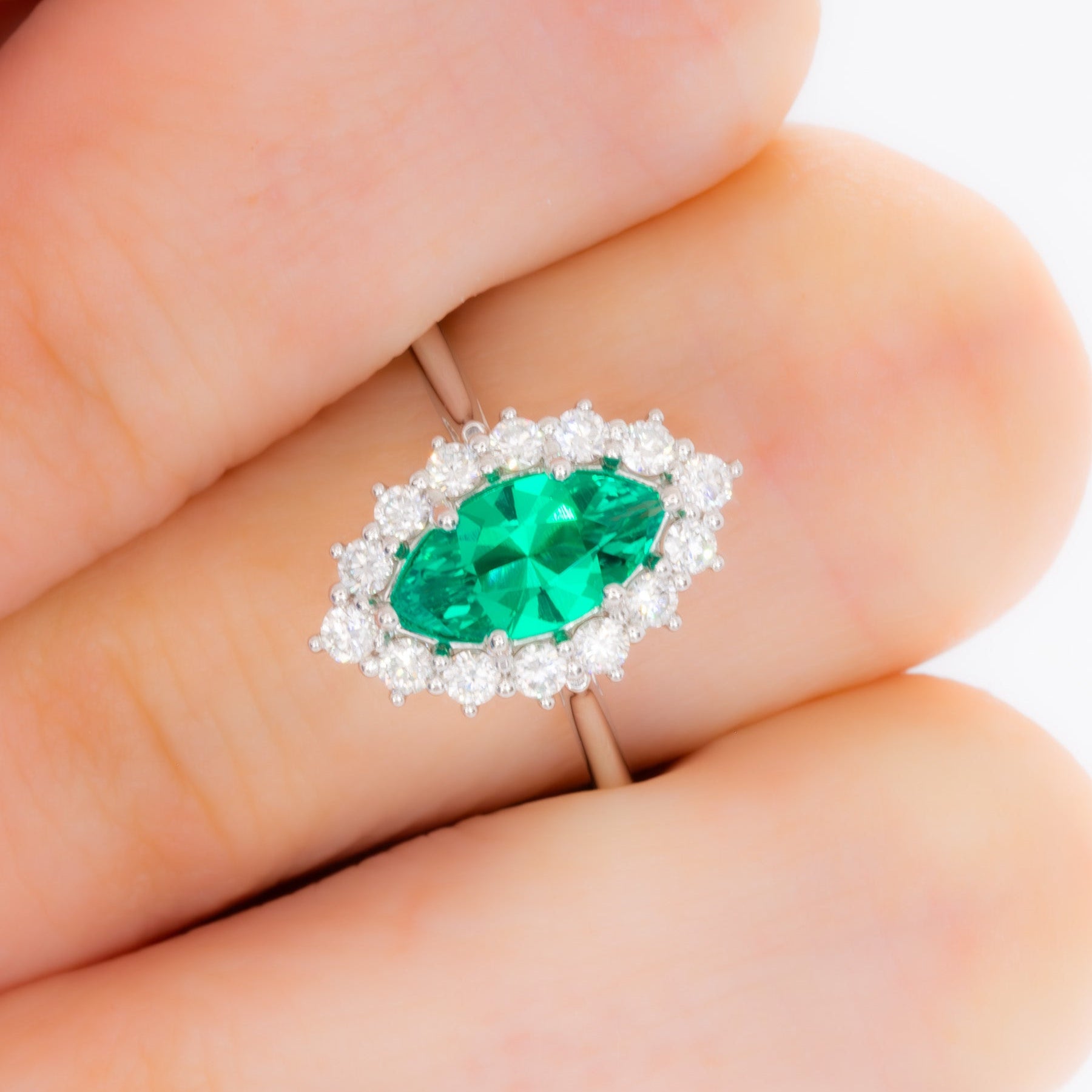 calypso halo engagement ring in white gold and marquise lab emerald