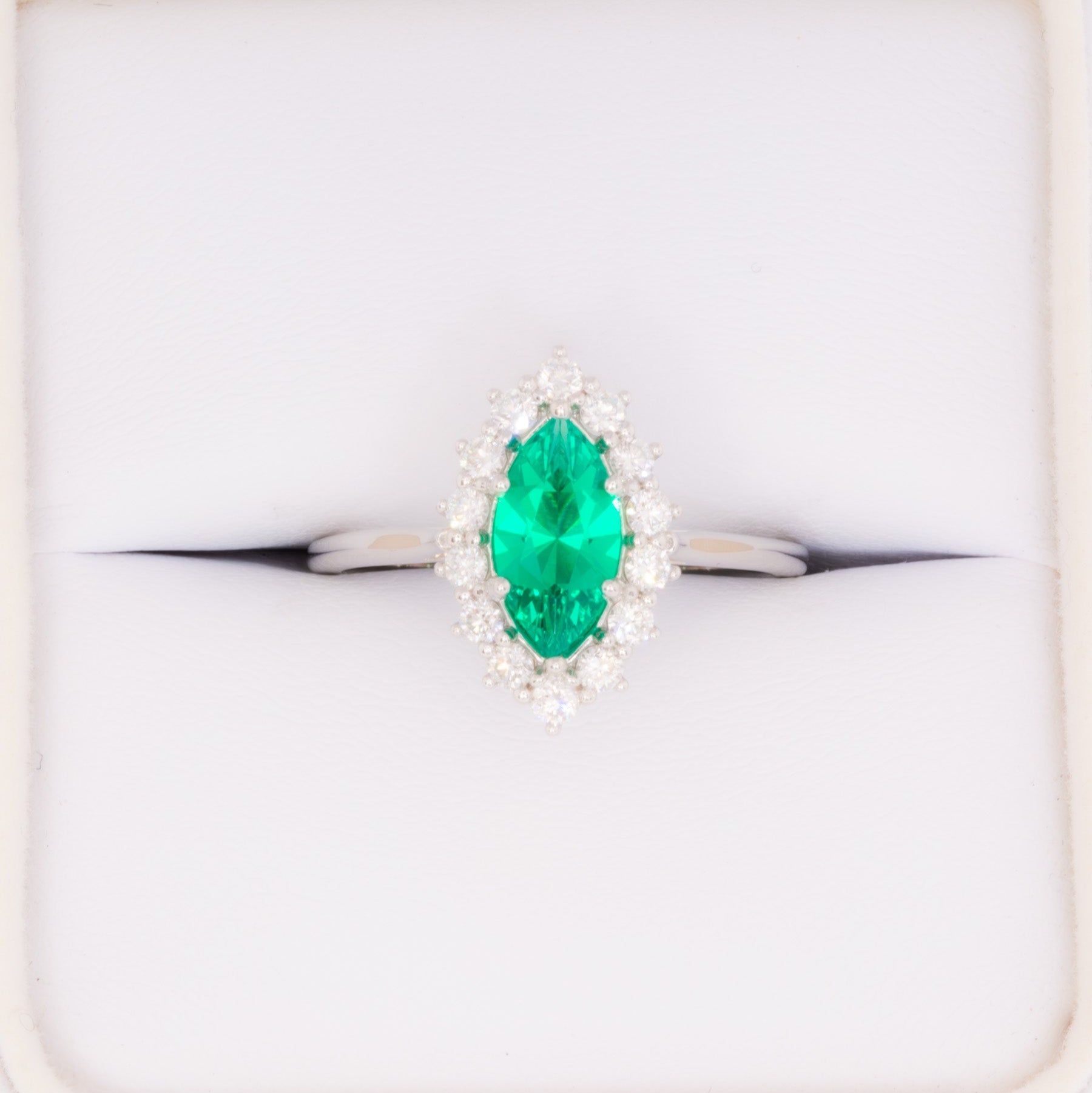 calypso halo engagement ring in white gold and marquise lab emerald