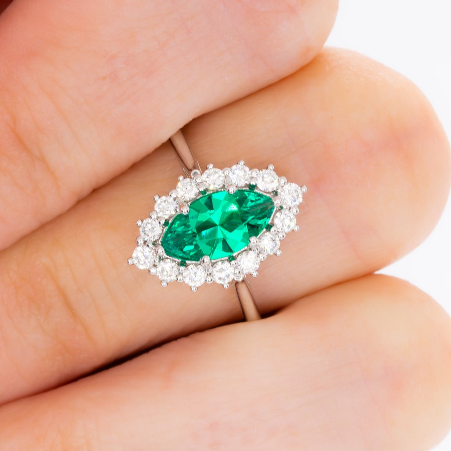 calypso halo engagement ring with emerald marquise