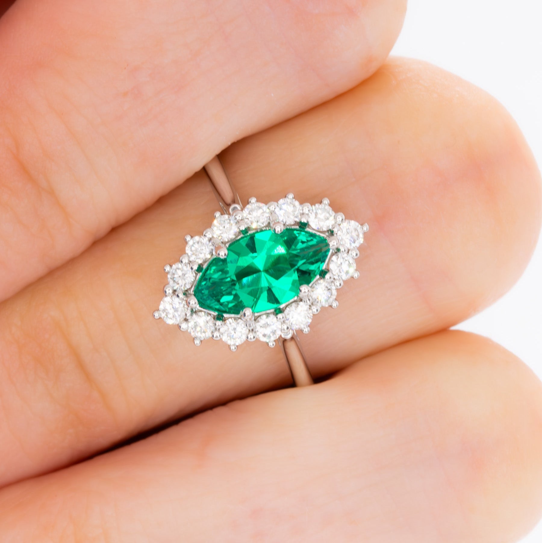 calypso halo engagement ring with emerald marquise