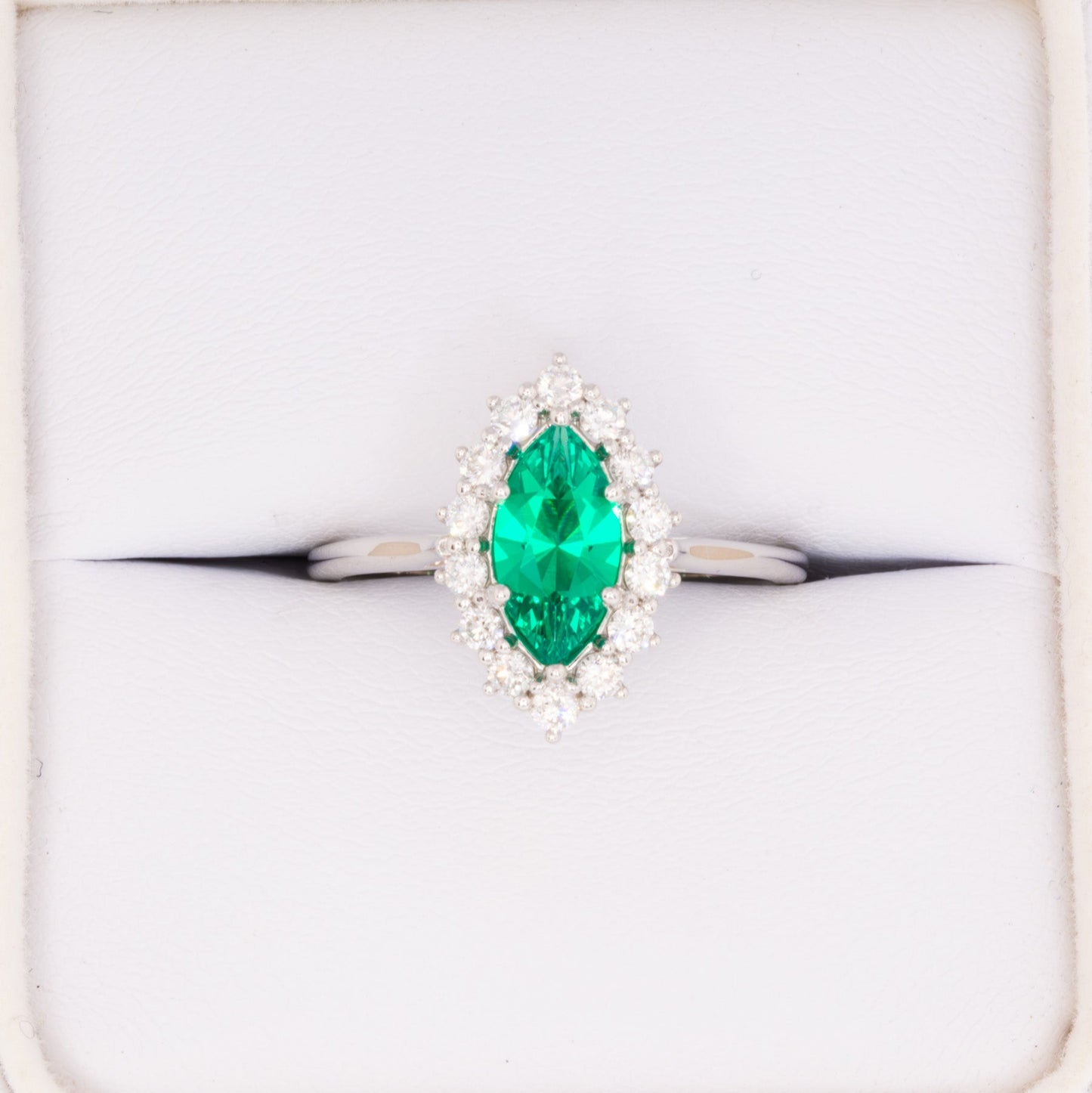 calypso halo engagement ring with emerald marquise