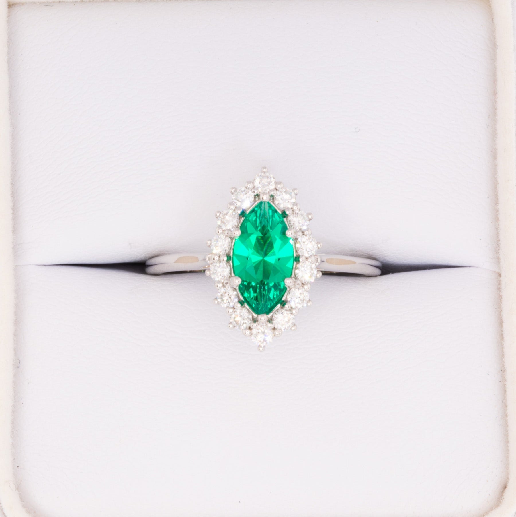 calypso halo engagement ring with emerald marquise