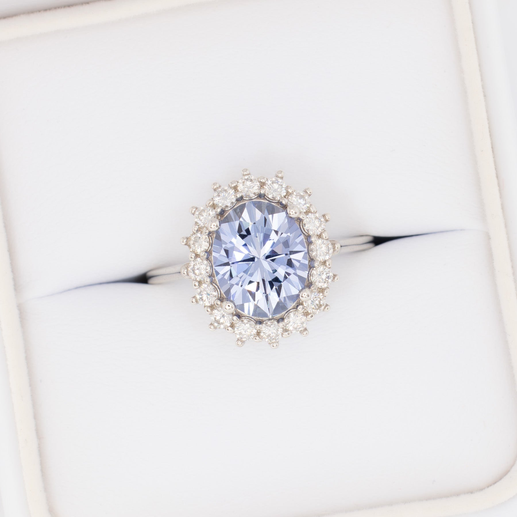 calypso halo engagement ring with oval blue lab sapphire