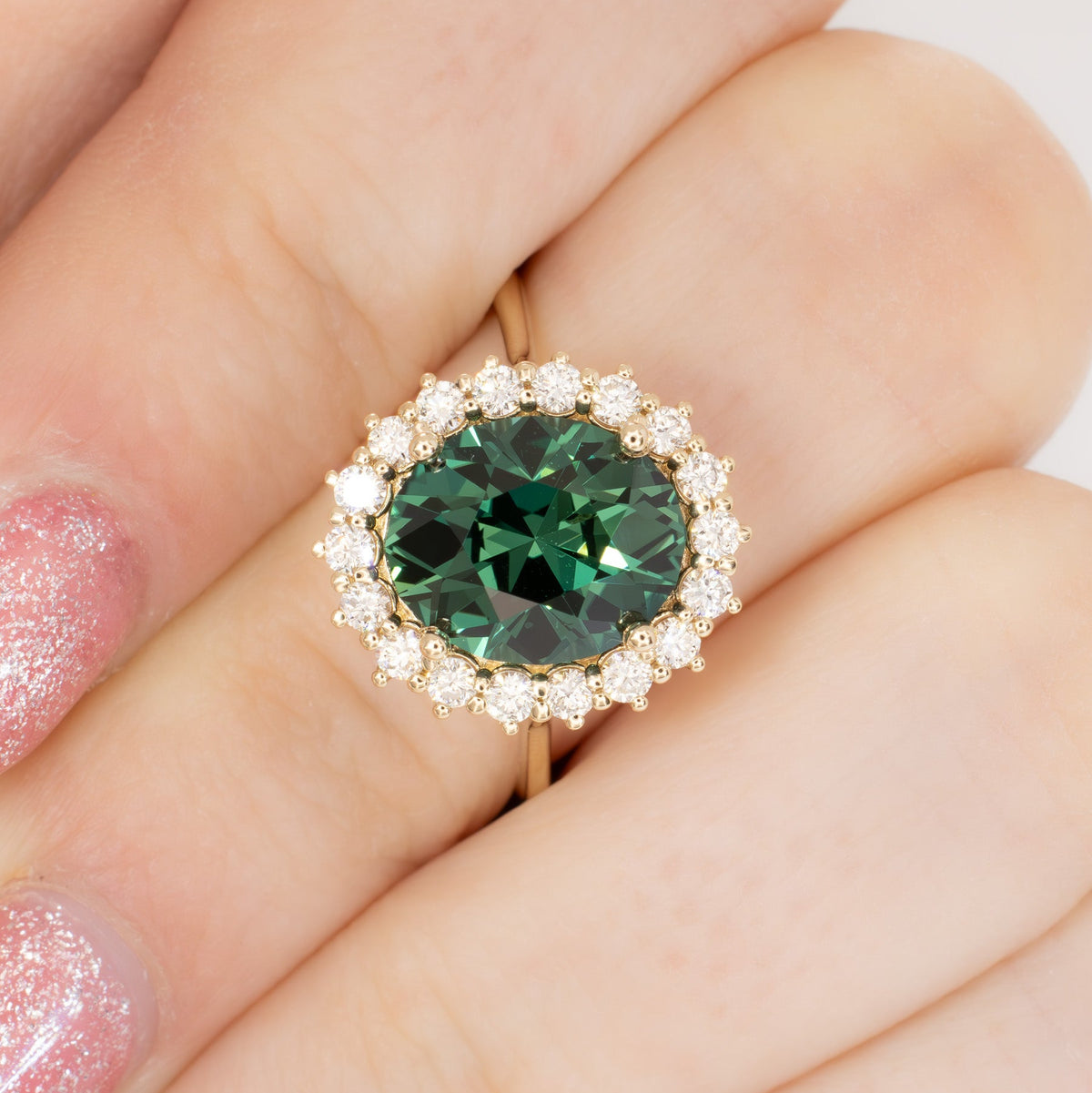calypso halo ring in yellow gold with oval green lab sapphire