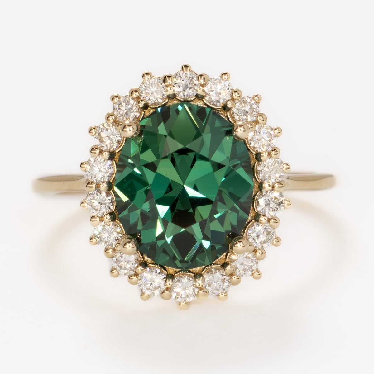 calypso halo ring in yellow gold with oval green lab sapphire