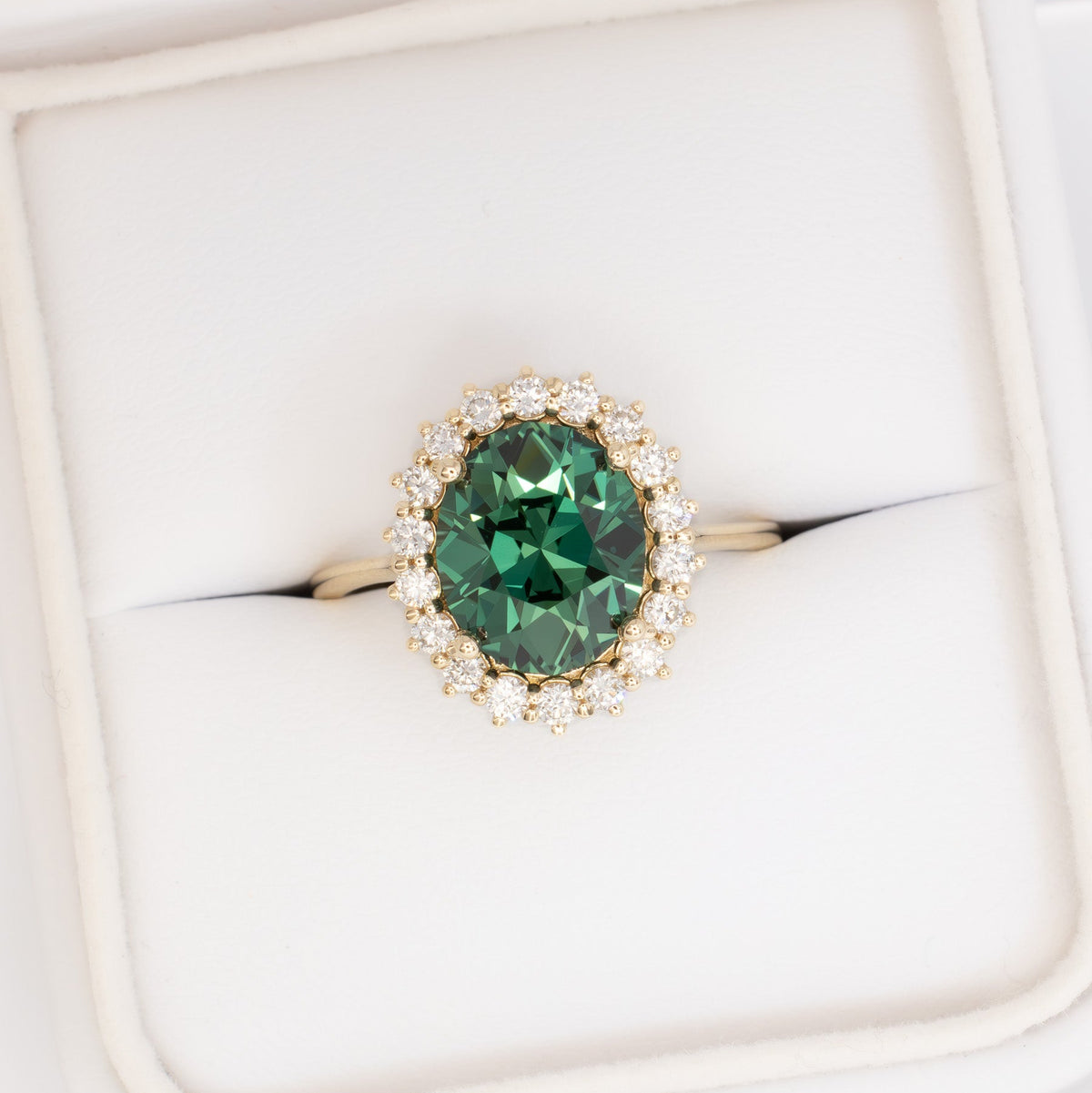 calypso halo ring in yellow gold with oval green lab sapphire
