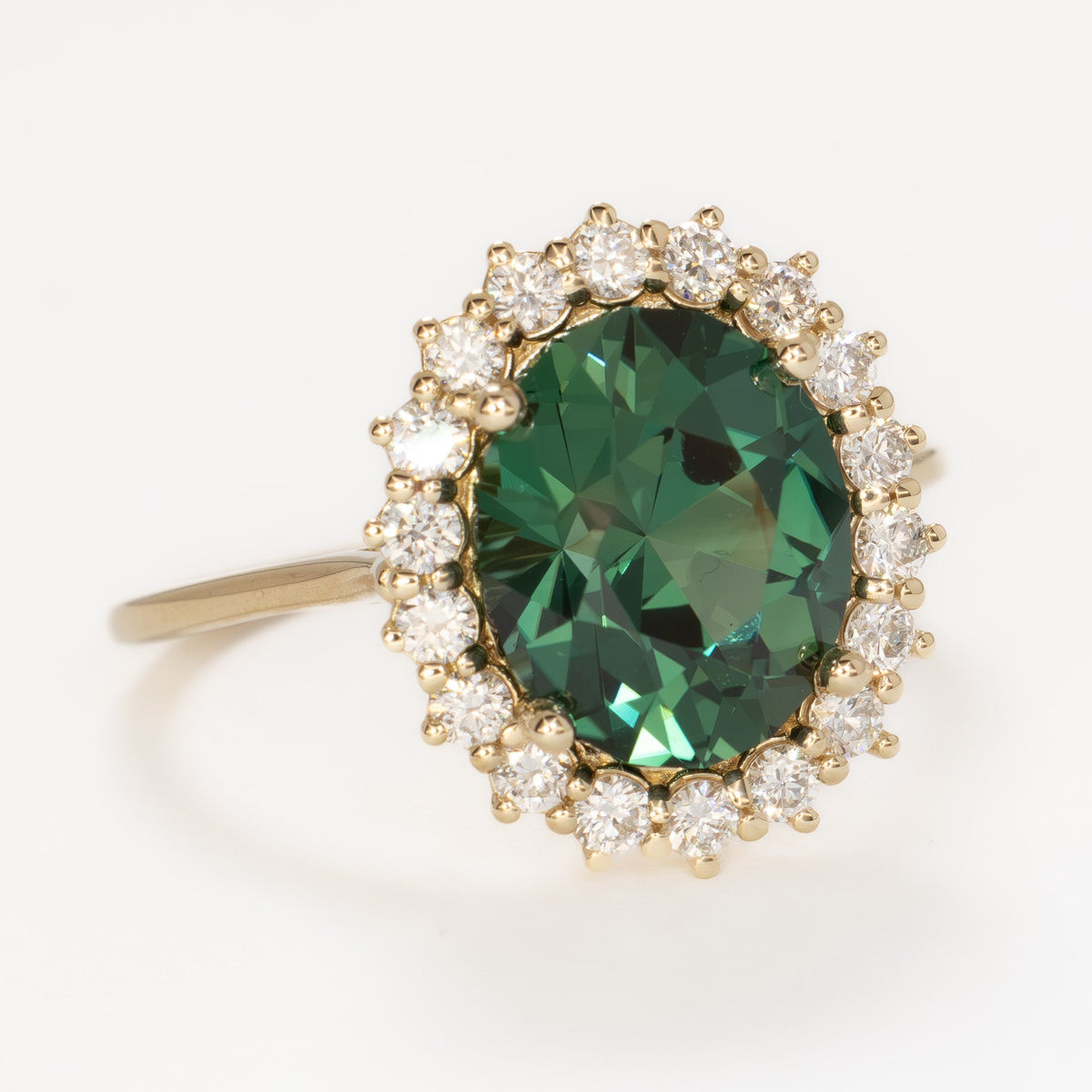 calypso halo ring in yellow gold with oval green lab sapphire