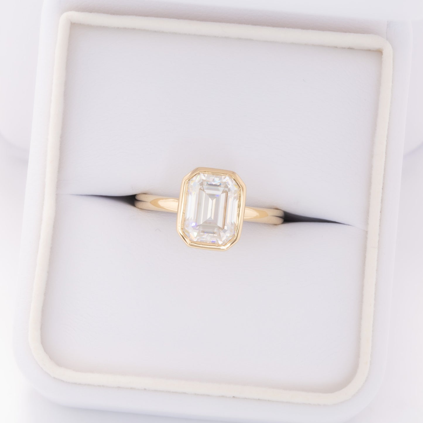 cami bezel set solitaire with step cut moissanite