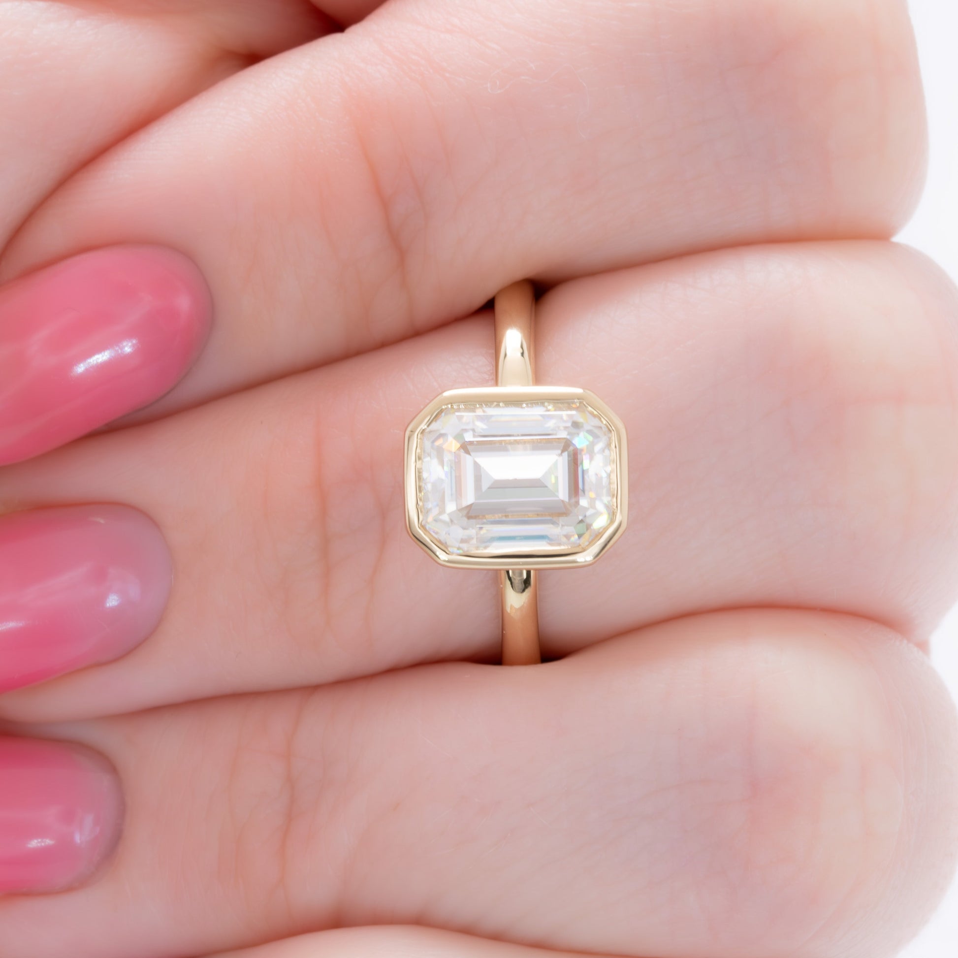 cami bezel set solitaire with step cut moissanite