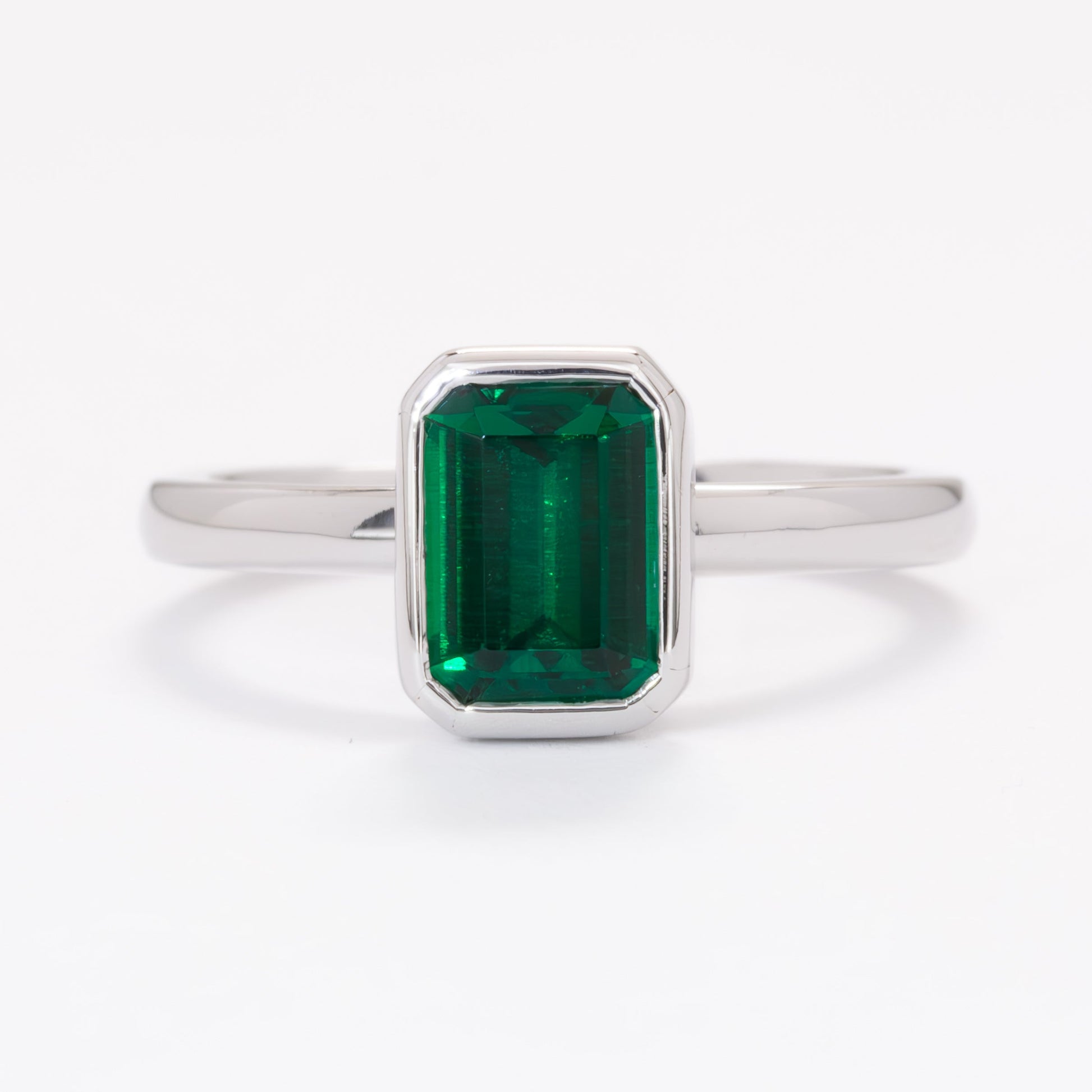 cami engagement ring with lab emerald step cut