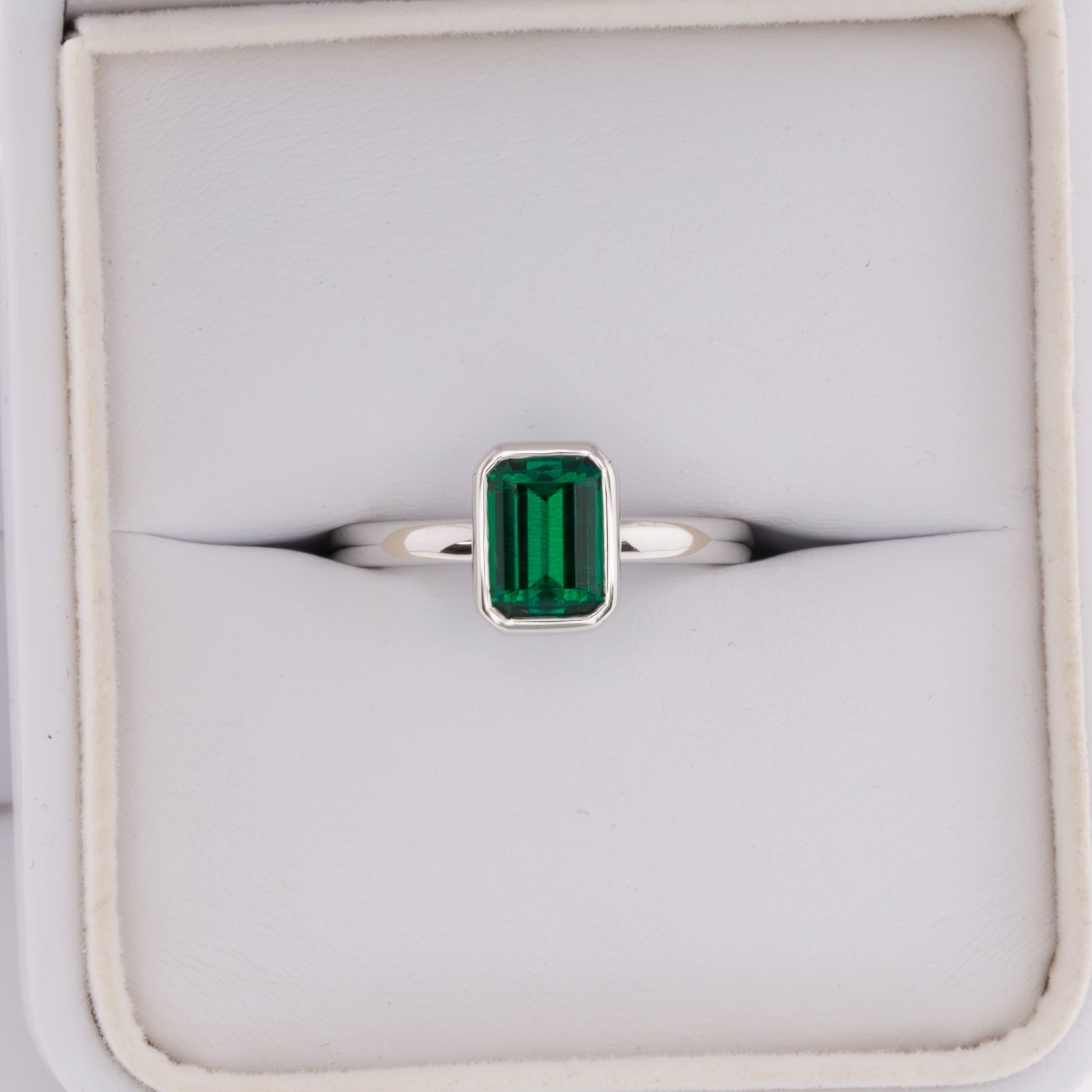 cami engagement ring with lab emerald step cut